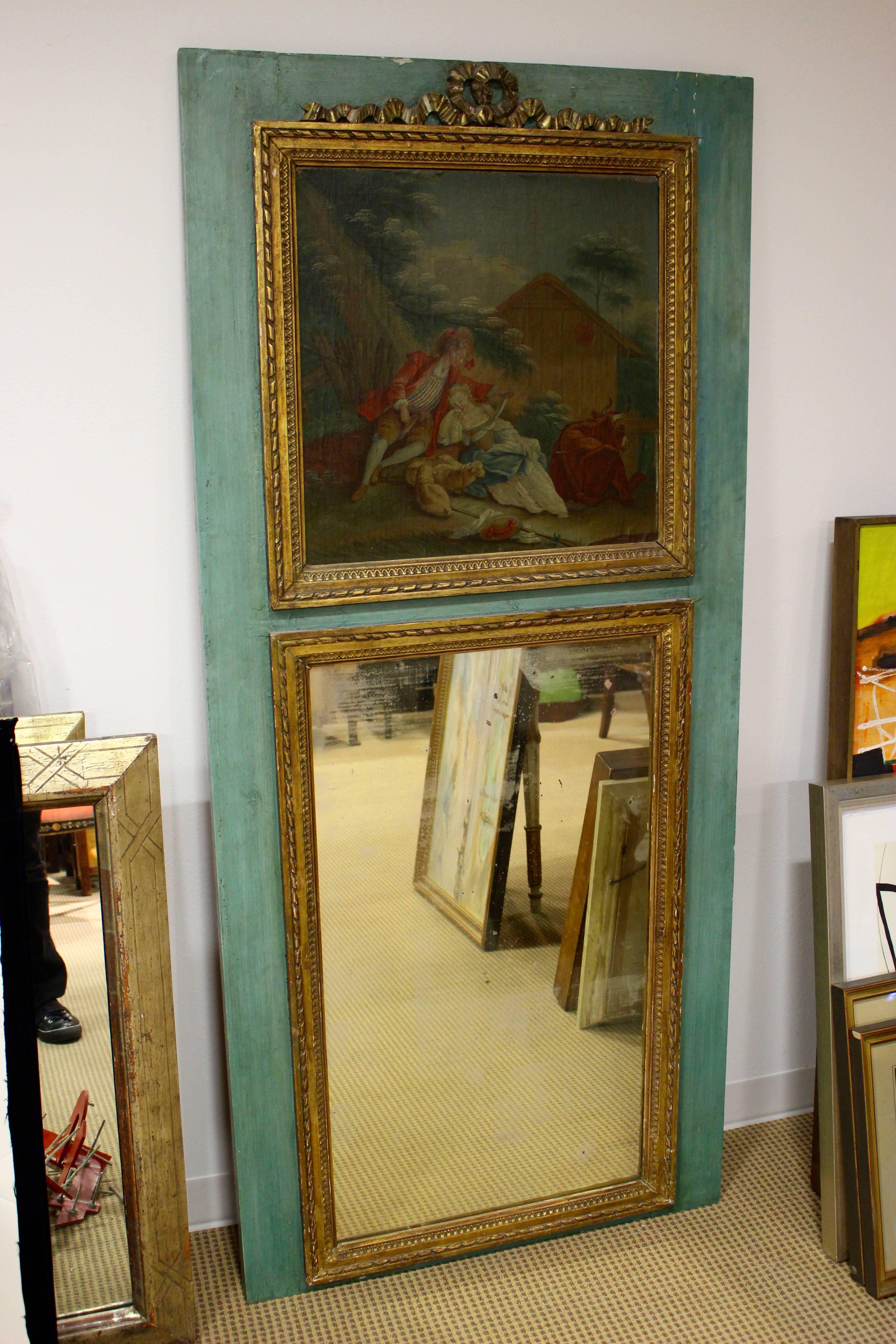 A French Louis XVI style painted trumeau mirror from the 19th century with trysting lovers painted scene and gilt accents. This exquisite Louis XVI style trumeau mirror features a blue/green background, allowing the exquisite painted scene and gilt