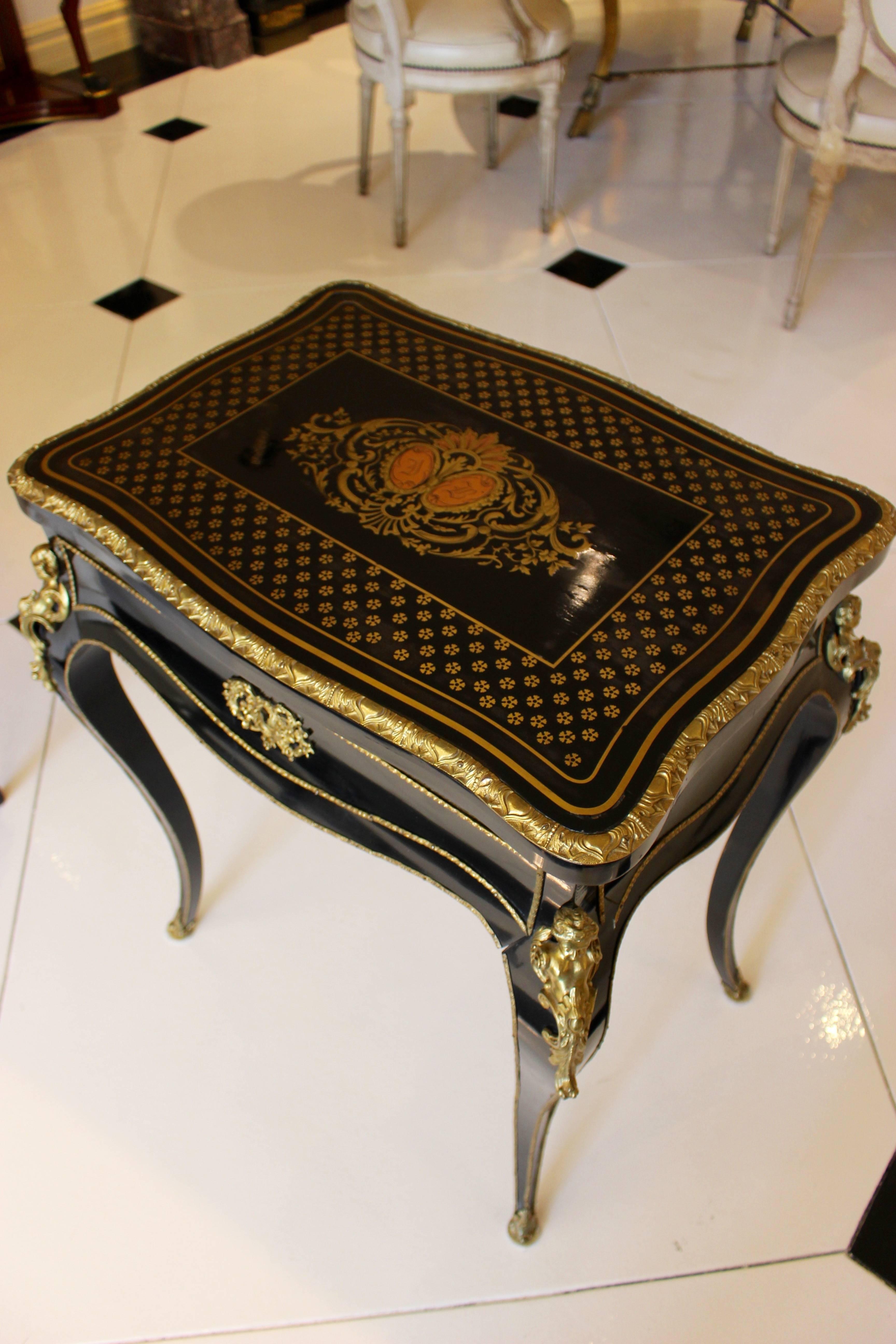 Chic Napoleon III worktable (travailleuse) ebonized, bronze-mounted and brass inlaid marquetry in the queens style (a la reine) with inlaid initials, France, 19th century.