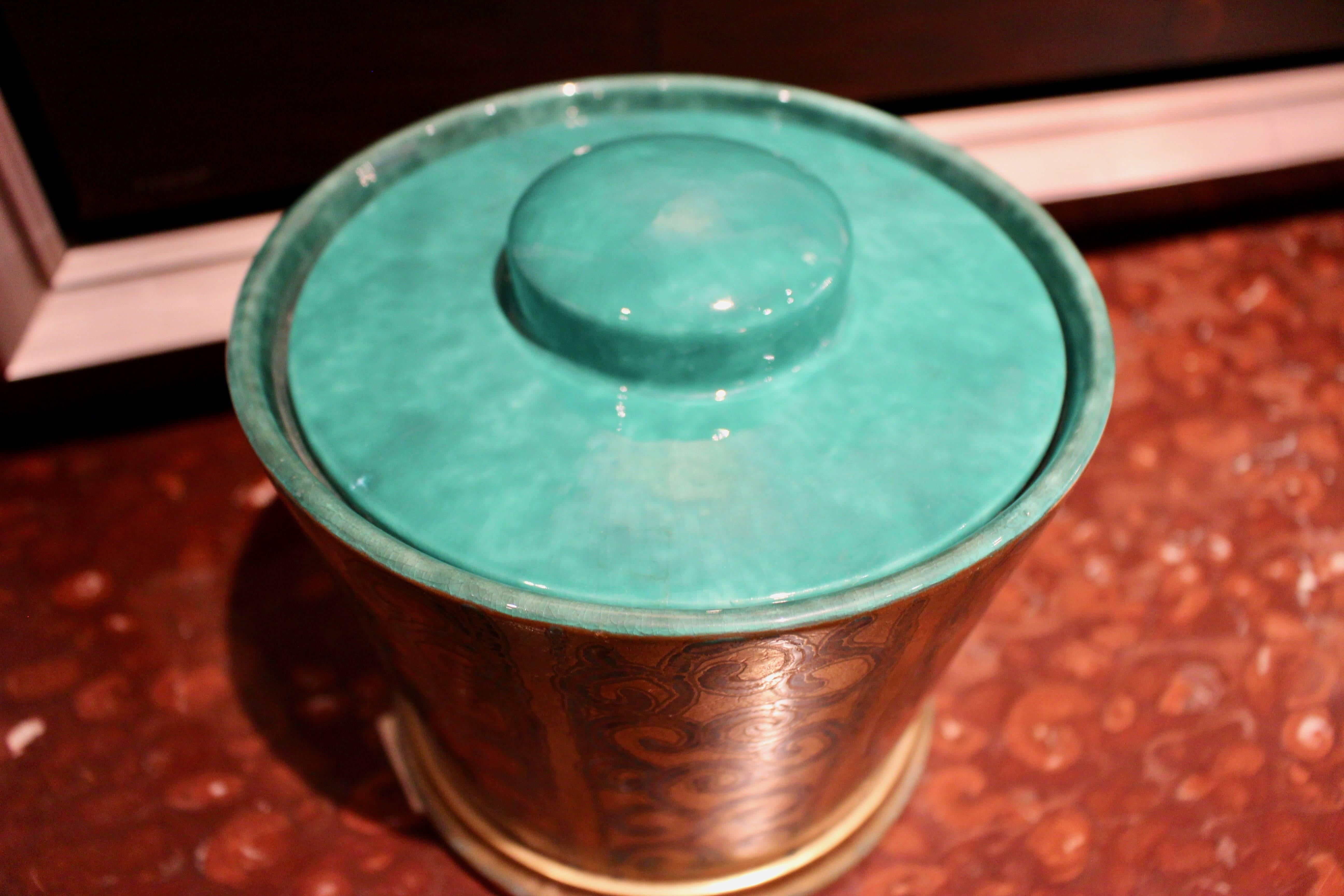 Elegant gold metal finish ice bucket reflecting the high point of design, circa 1920.