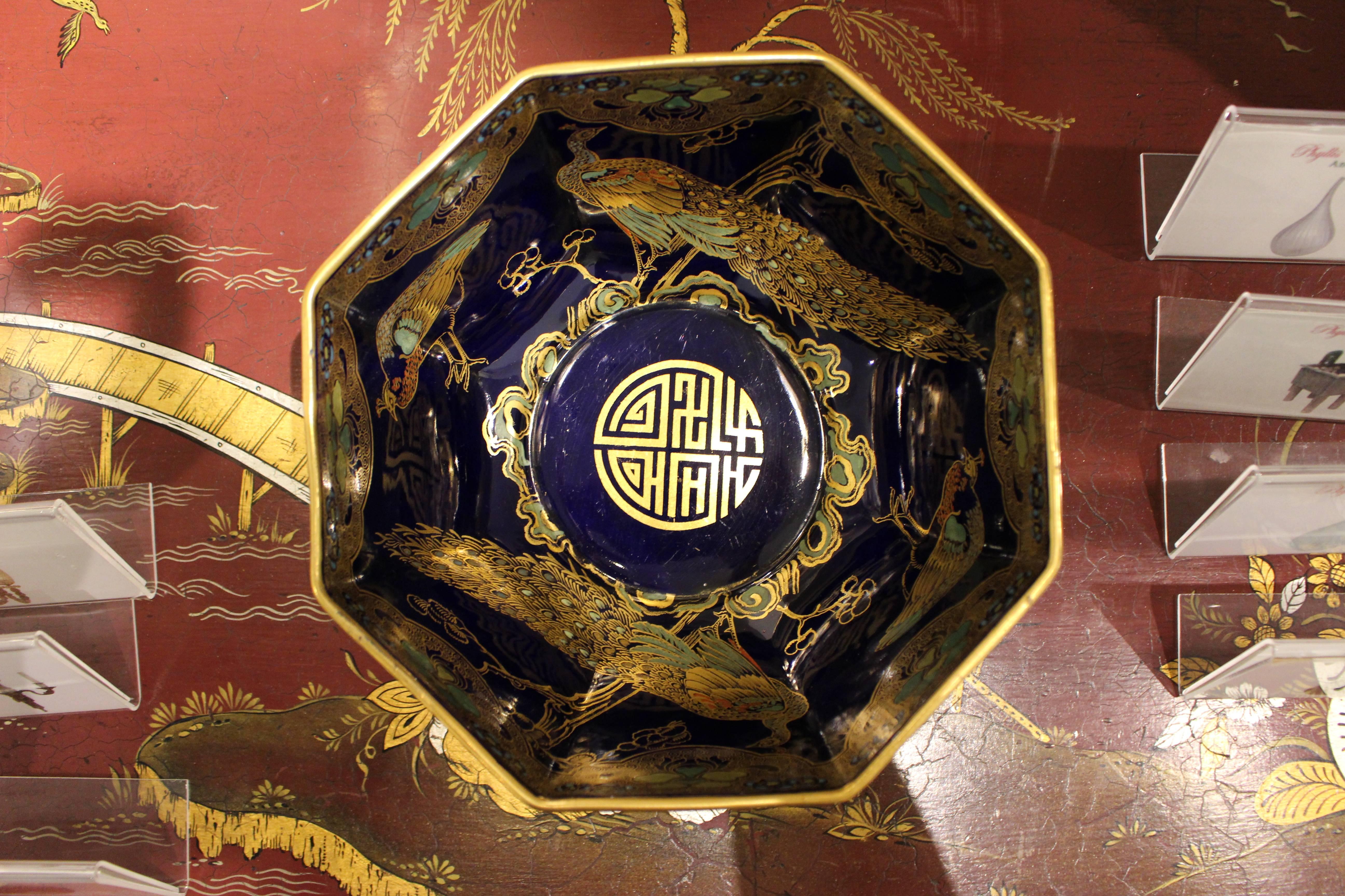 An elegant Mason’s ironstone Chinese style octagonal bowl decorated with delicate gilt and colored animal designs against a deep Mazarine-blue ground. A rich decoration animates the inside with a gilt rim and scallops enclosing stylized lotus flower