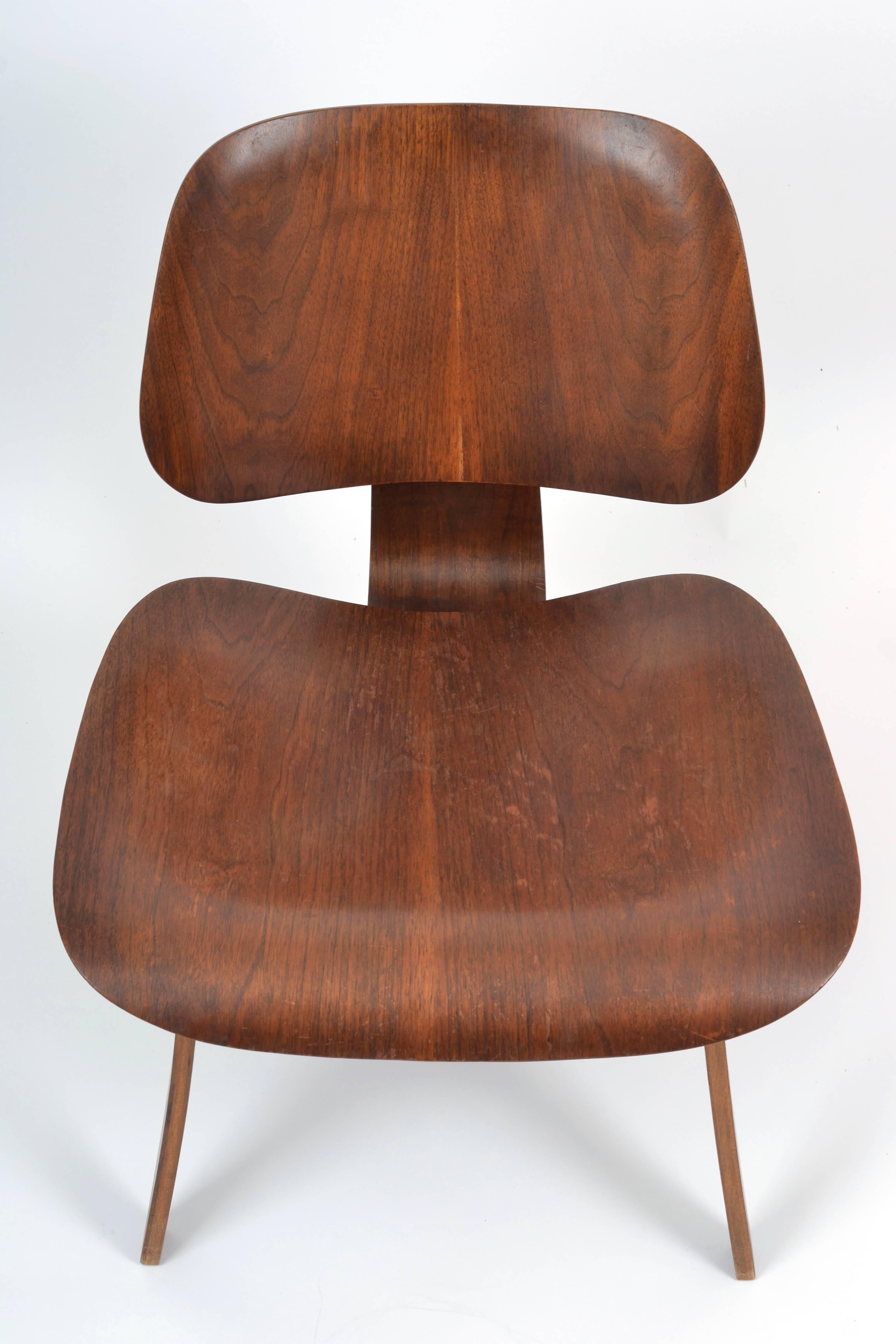 A rare dark walnut example in incredible condition with no chips and minimal wear for it's age. The Herman Miller/Evans Products Company label is intact.