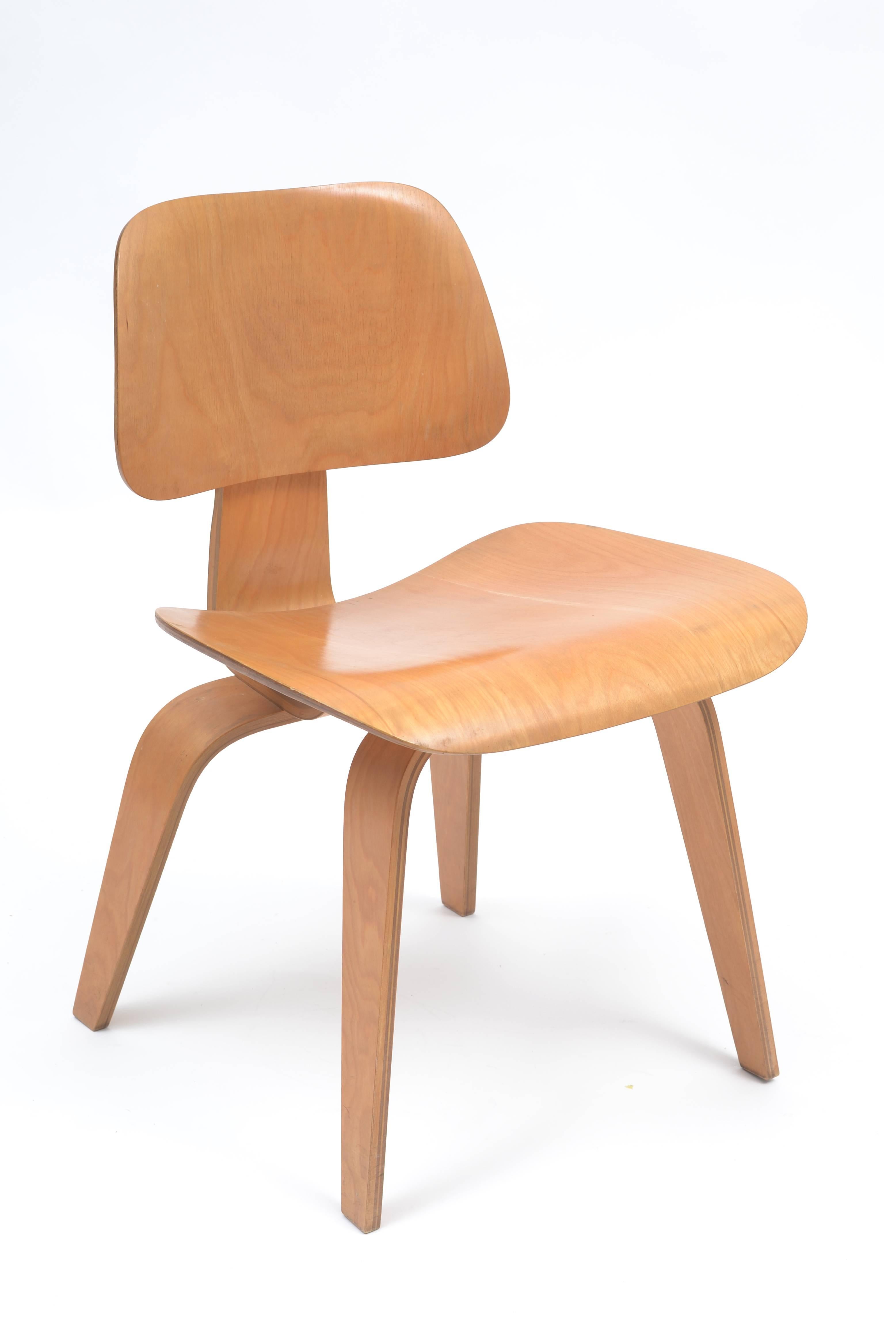 A stunning, all original set of well preserved Eames designed DCW chairs produced in the 1940s by Evans Products Company and distributed by Herman Miller. This birchwood set has minimal wear considering the age. The four chairs have no chips to the
