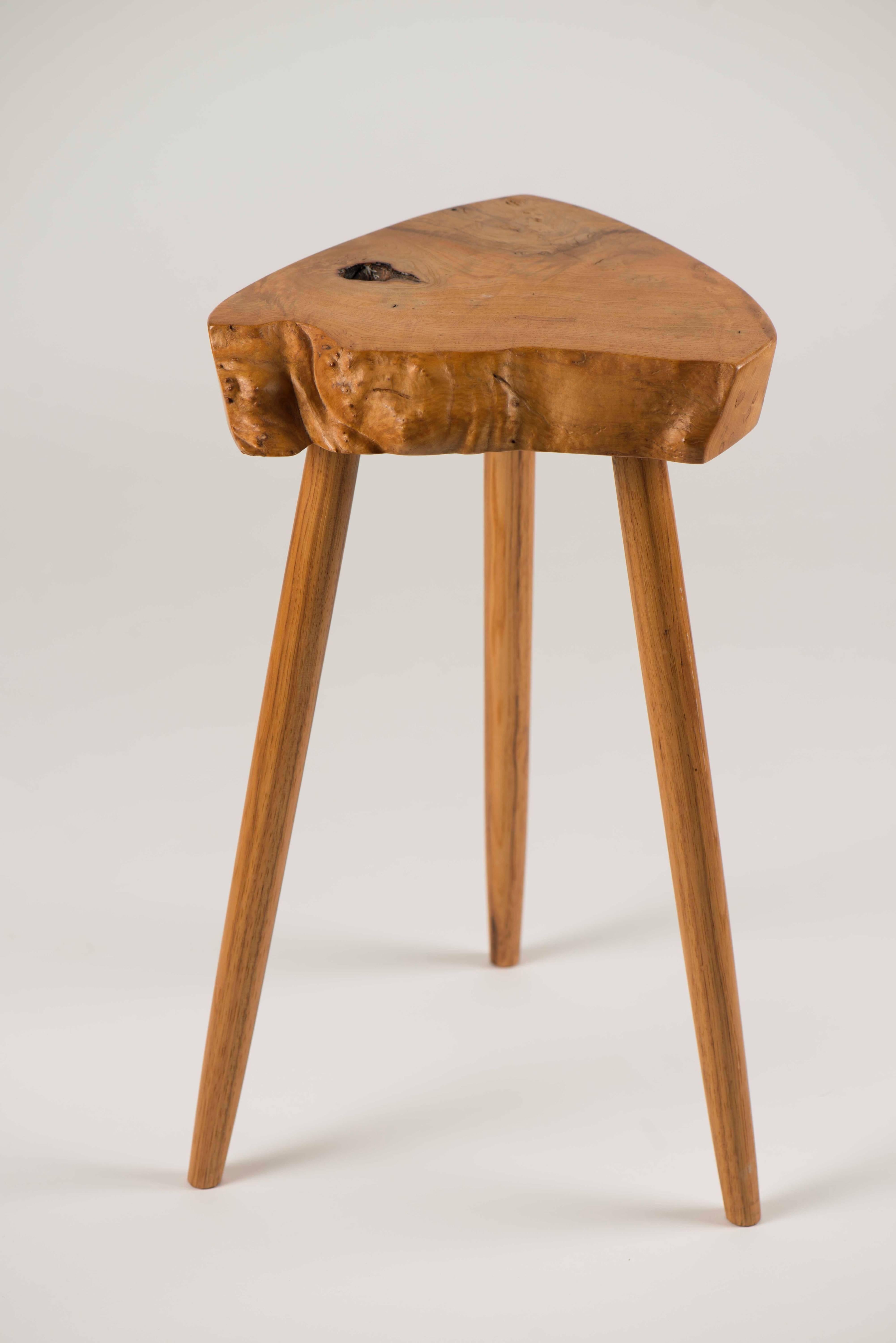 French olive ash and hickory side table by George Nakashima. A fantastic example of the work of Nakashima in a rare wood combination featuring the live edge and tapered legs.