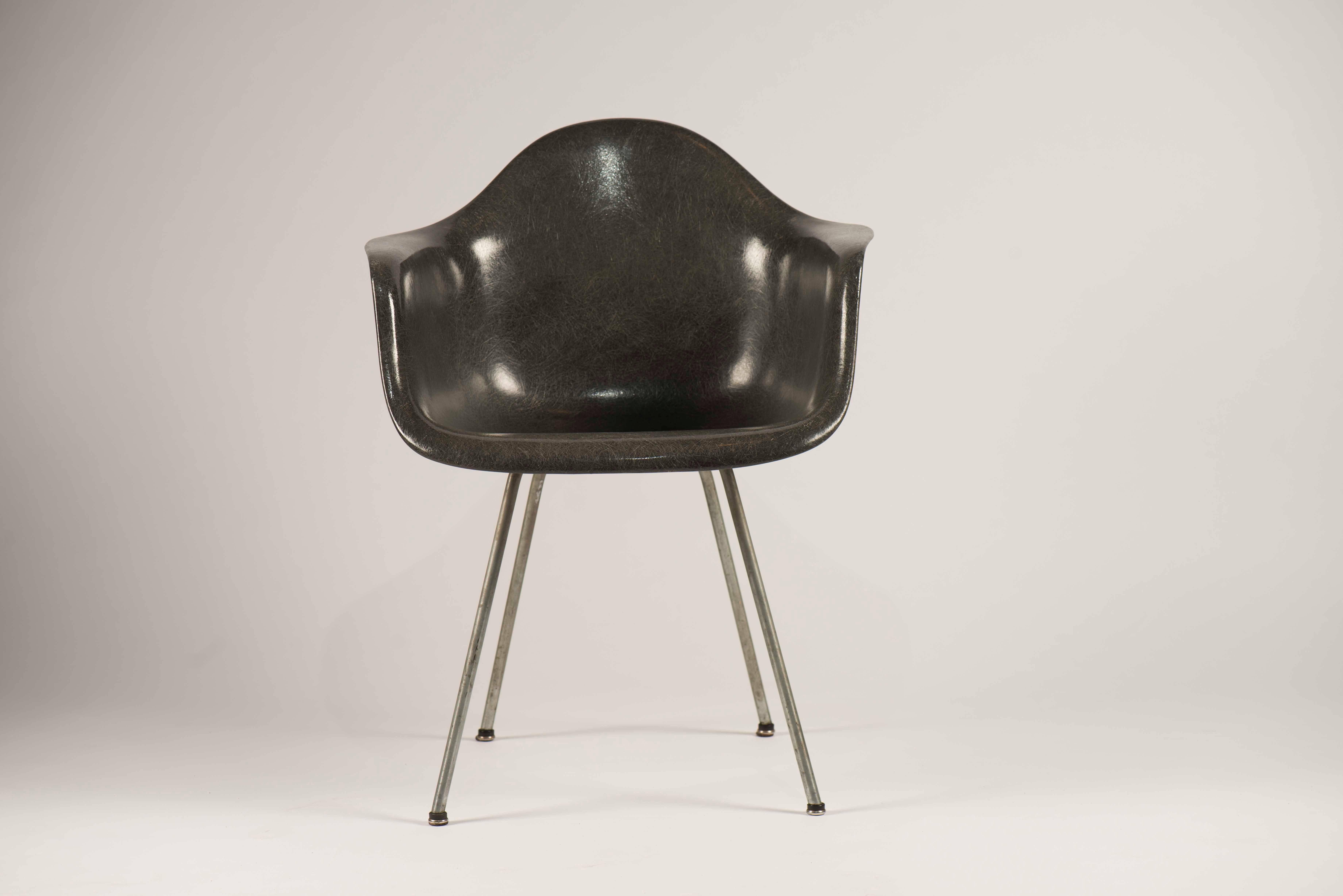An excellent example of the earliest, 1950s fiberglass chairs designed by the office of Charles Eames, manufactured by Zenith Plastics and distributed by Herman Miller. This chair features the signature checkerboard label, large shock mounts Domes