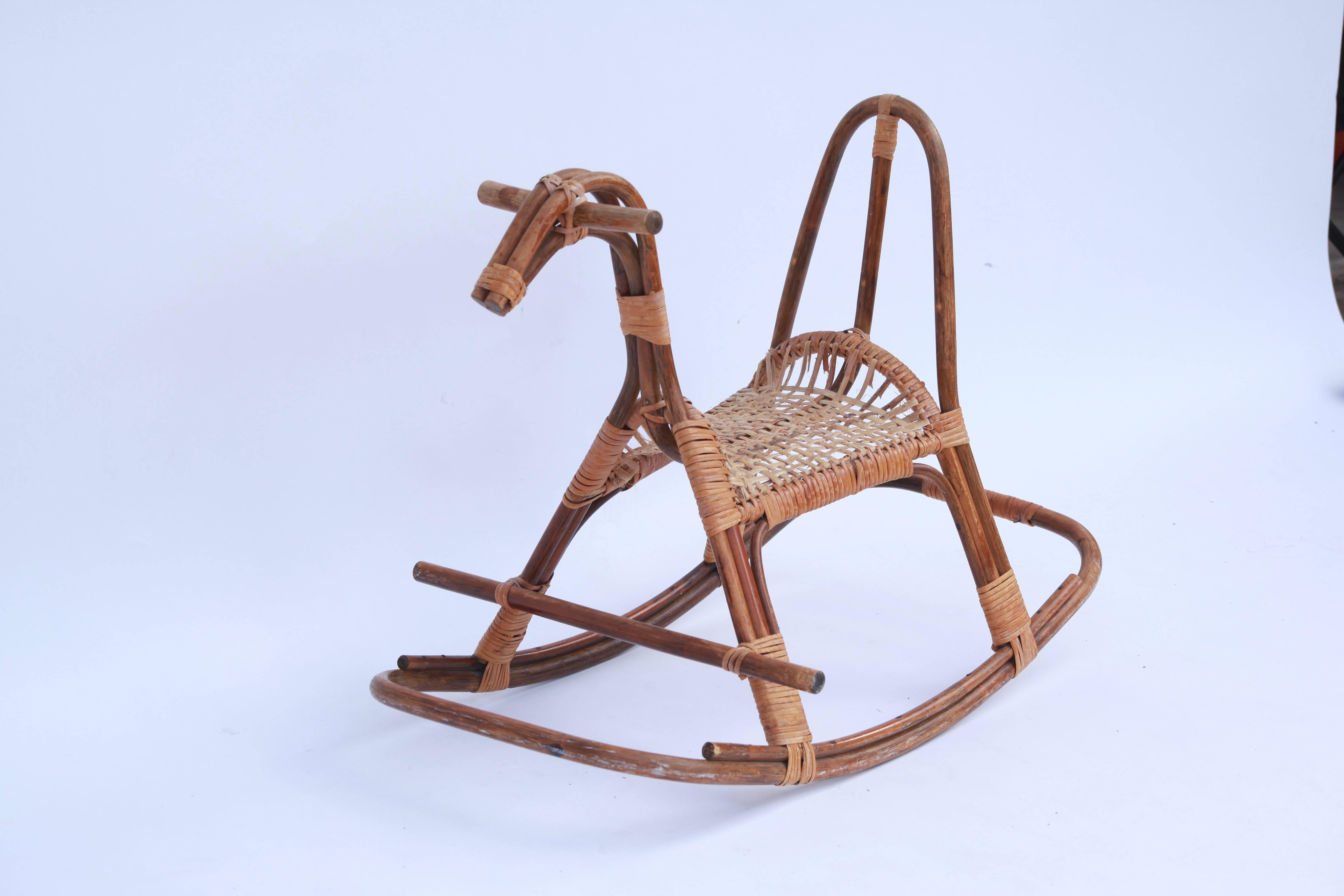 Danish rocking horse constructed of rattan and bound with caning.