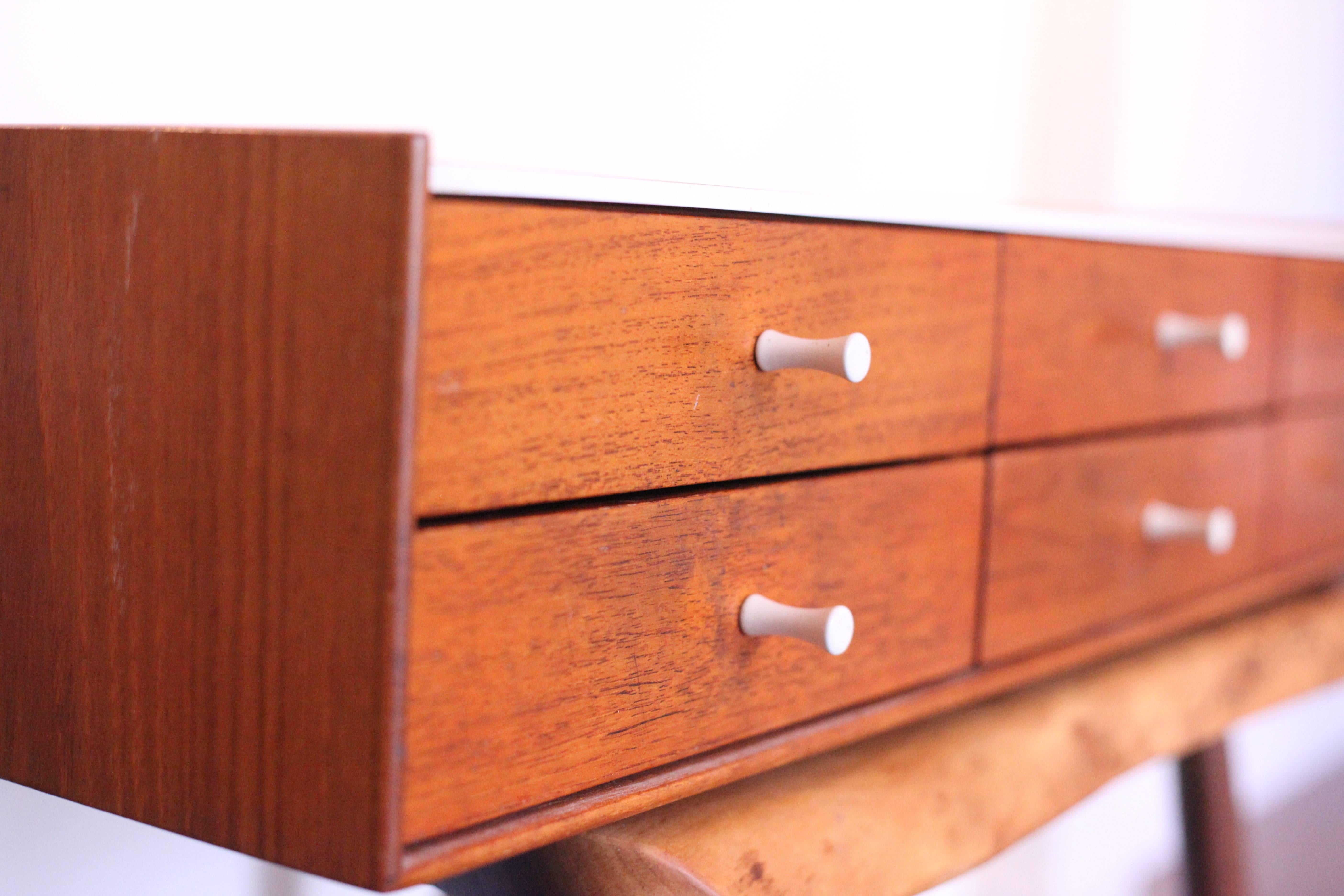 Vintage, timeless George Nelson design in rosewood with porcelain pulls.