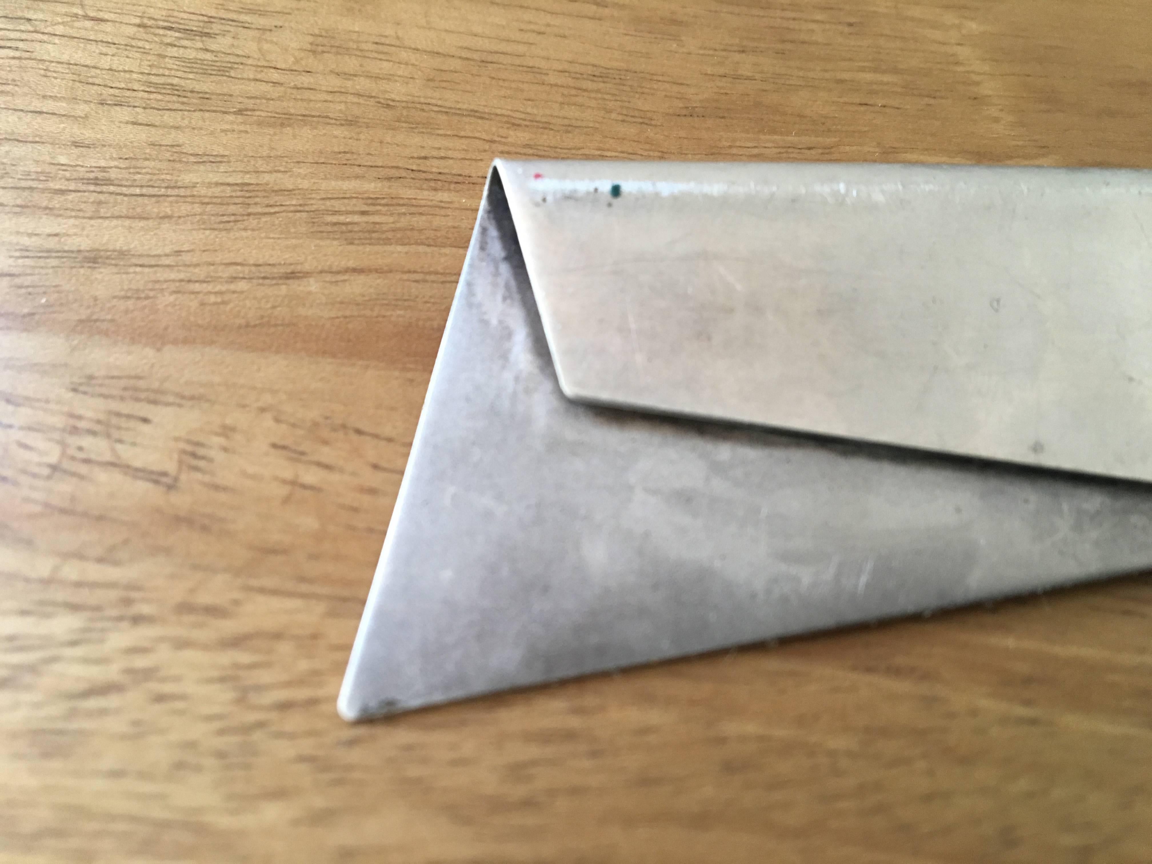 Folded sterling silver brooch. Signature is illegible.