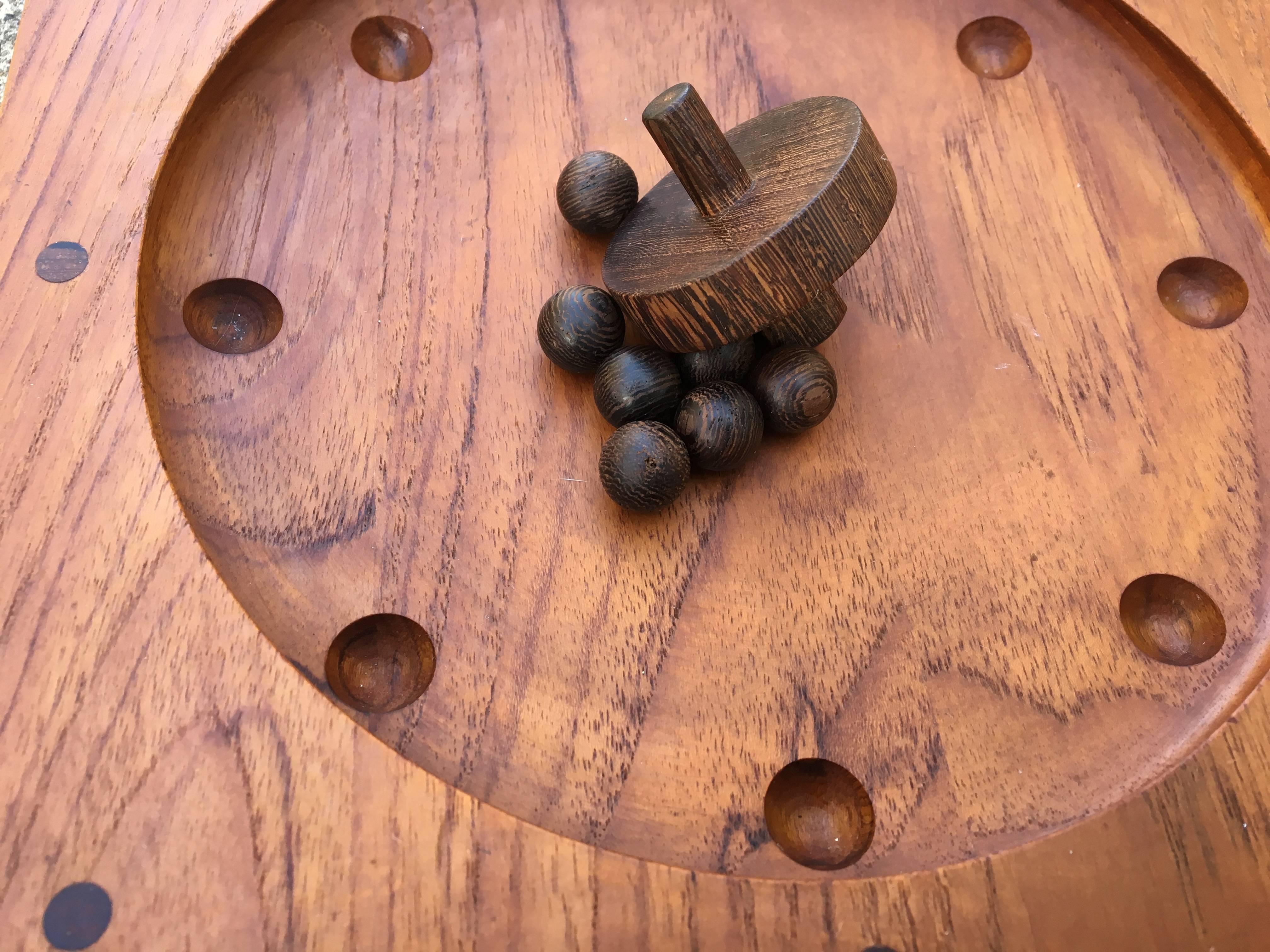 An extremely addicting game designed by Piet Hien for Skjøde of Skern. Teak game board with seven rosewood balls and rosewood top.