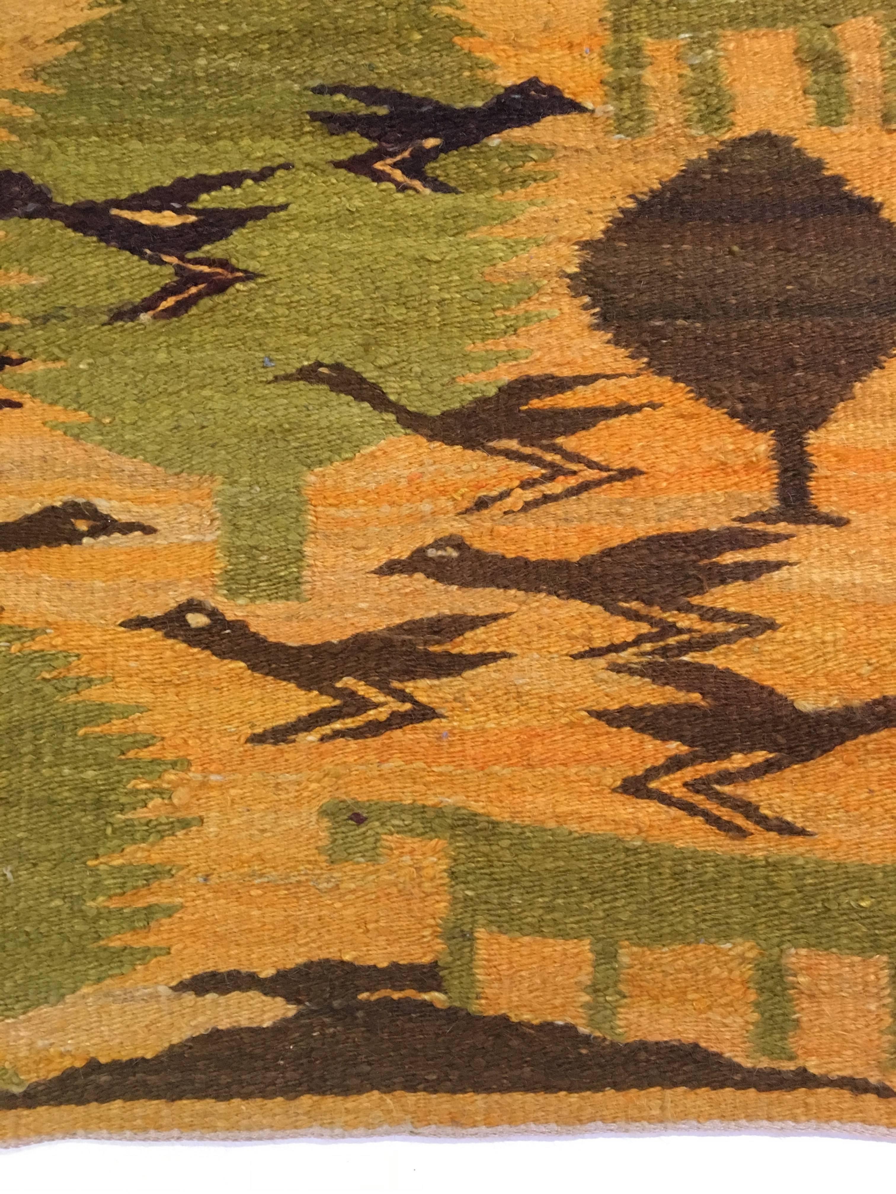 Beautiful handmade Scandinavian rug depicting people, animals and trees. Woven out of natural fibers in muted yellow, green, orange and brown hues. We can not find another example. Excellent vintage condition.