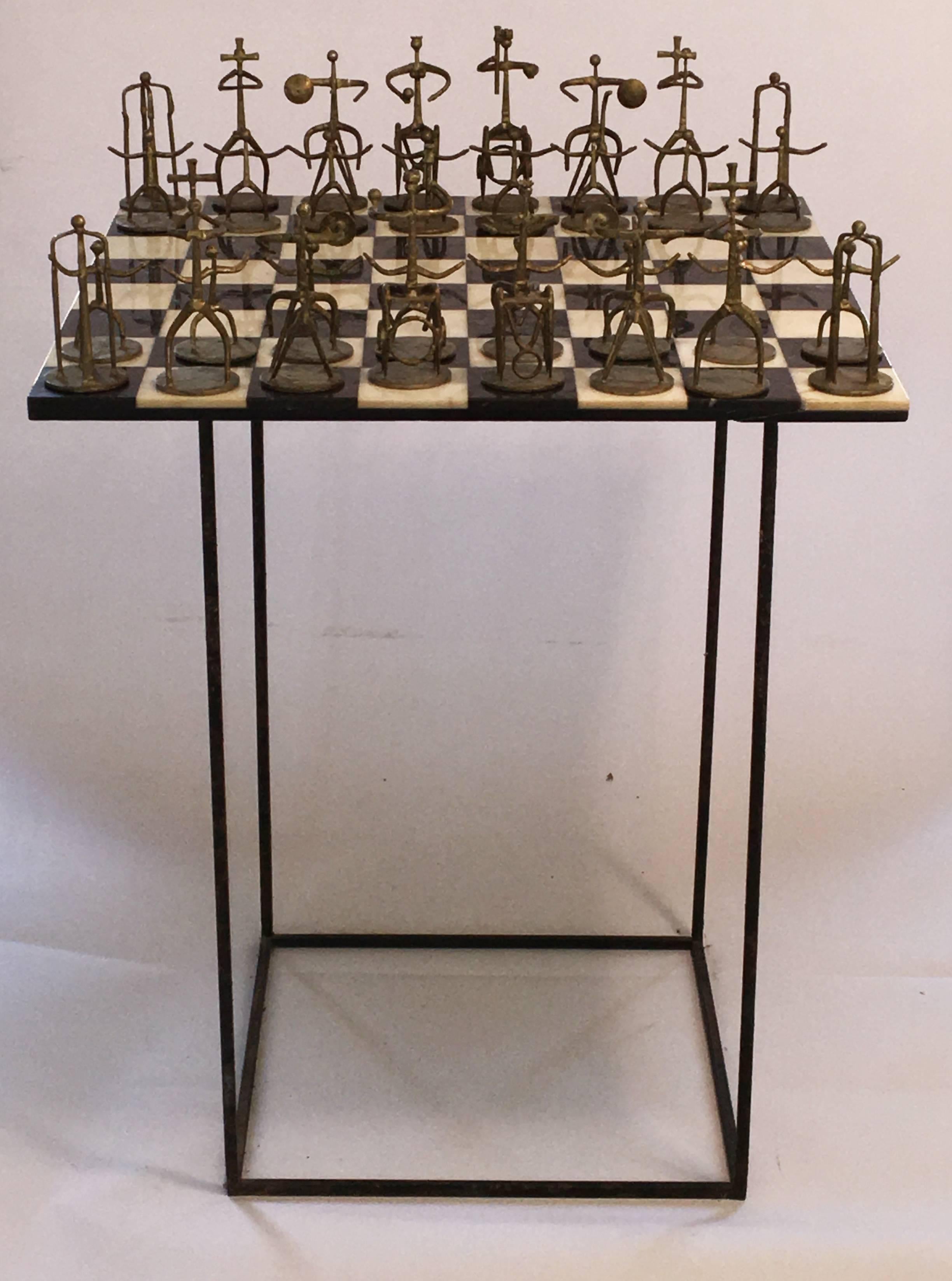 Beautiful chess set designed by Pittsburgh based sculptor Henry Burstynowicz. Chessboard constructed out of marble with amazing characters constructed out of steel and bronze. Acquired directly from a family member and this is one of only two that