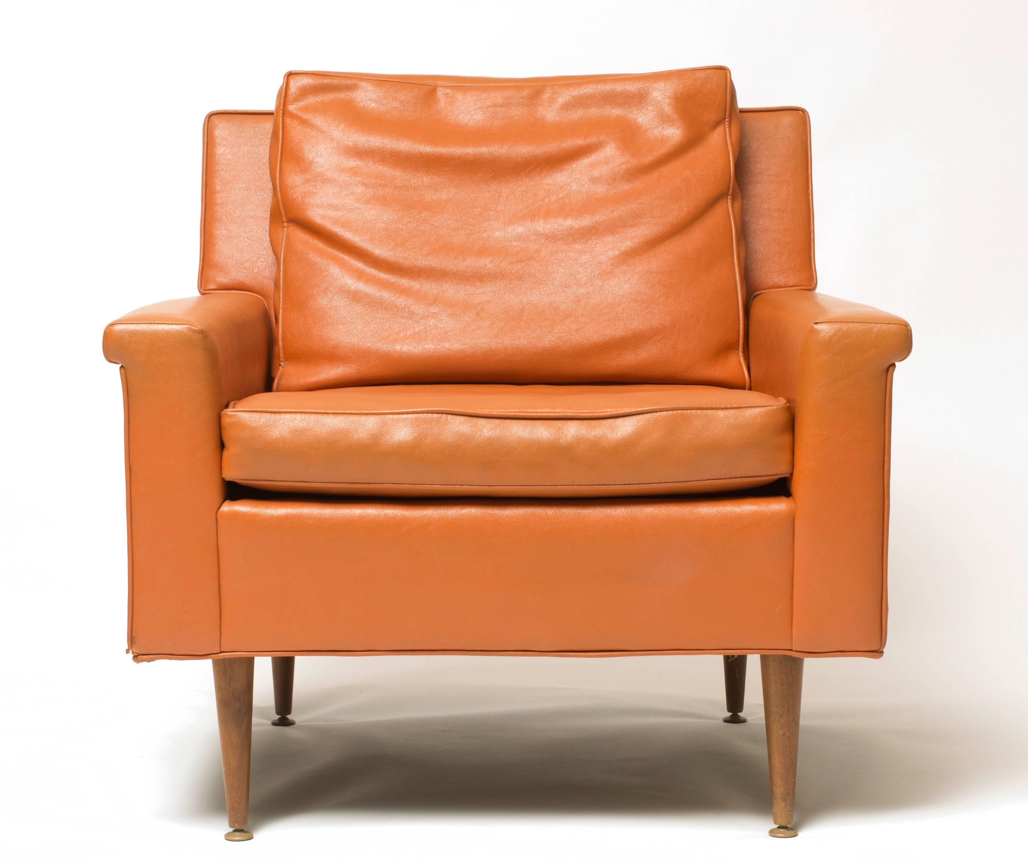 A rare Milo Baughman design featuring a durable burnt orange vinyl upholstery on sleek tapered wooden legs.