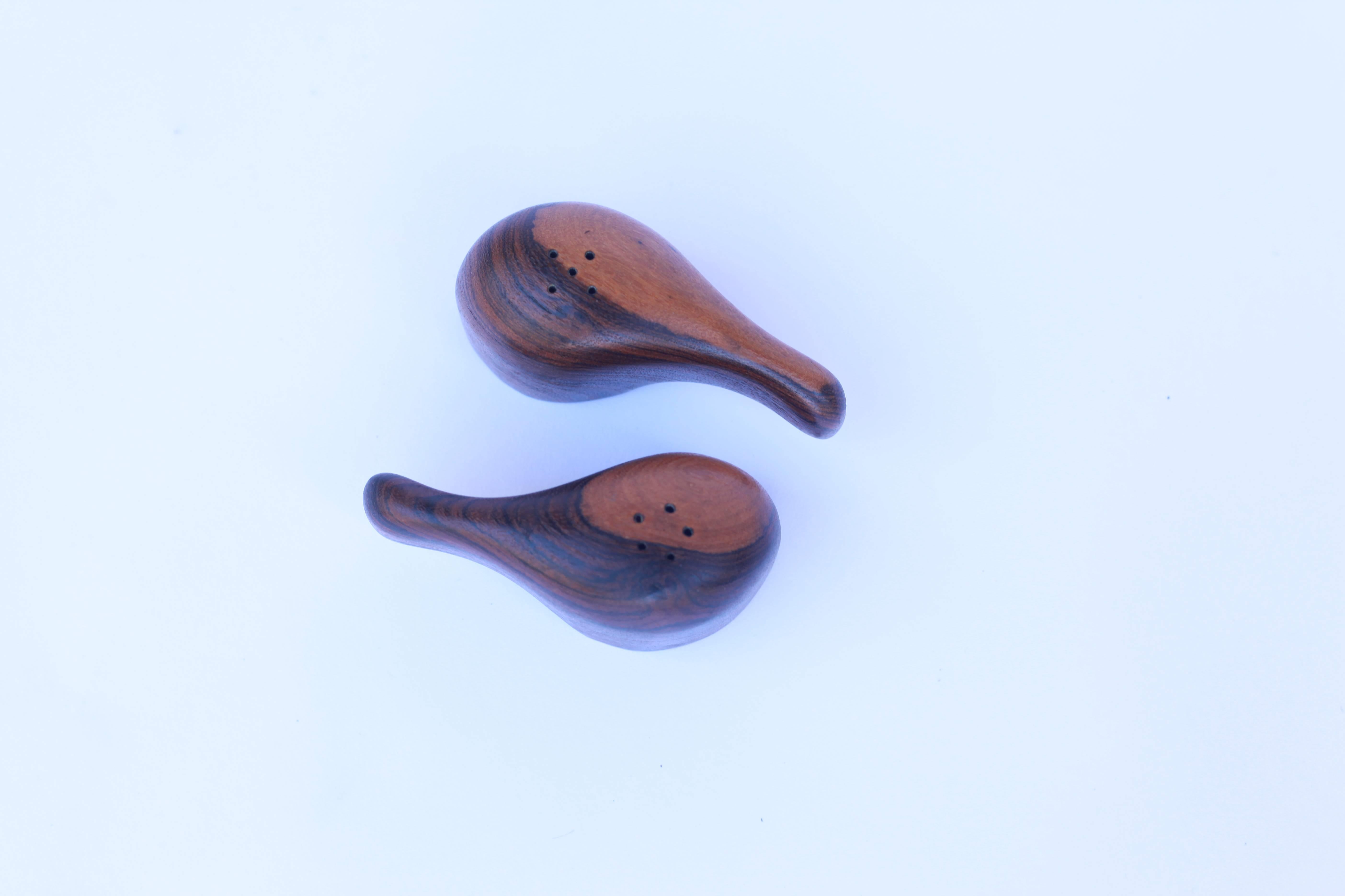 A wonderful set of salt and pepper shakers in a gorgeous exotic wood which appears to be either rosewood or cocobolo.