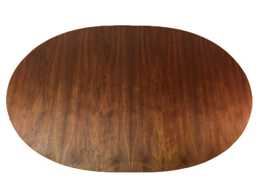 Beautiful walnut dining table designed by Paul McCobb for the Irwin collection manufactured by Calvin Furniture. The design utilizes the combination of aluminium and walnut. No leaves.