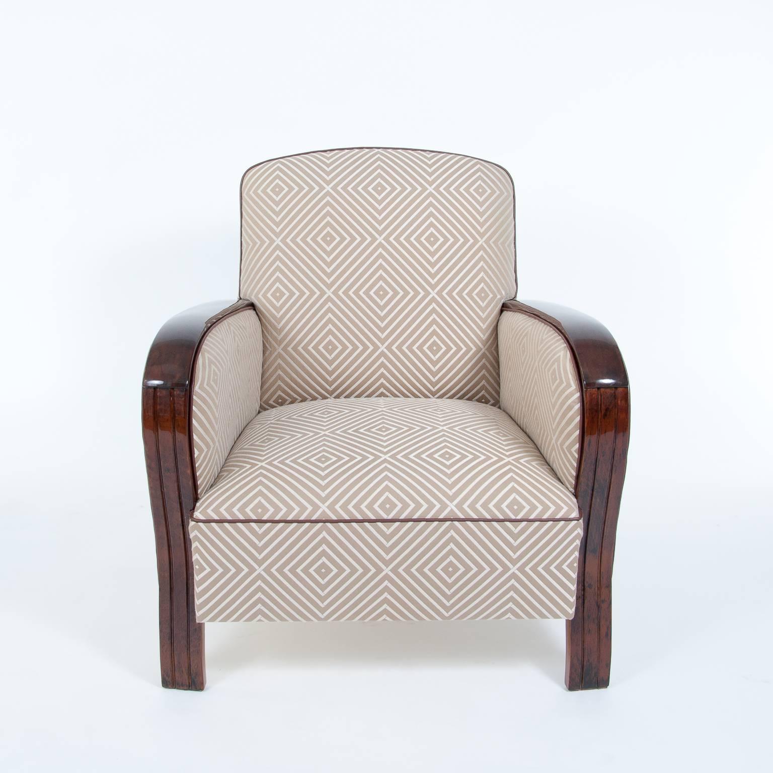High quality, French Art Deco club chairs from France around 1940. The wooden armrests have a glossy polish and a creme-white upholstery with rectangle ornaments. The cord edge is made from artificial leather and fits perfect to the same colored
