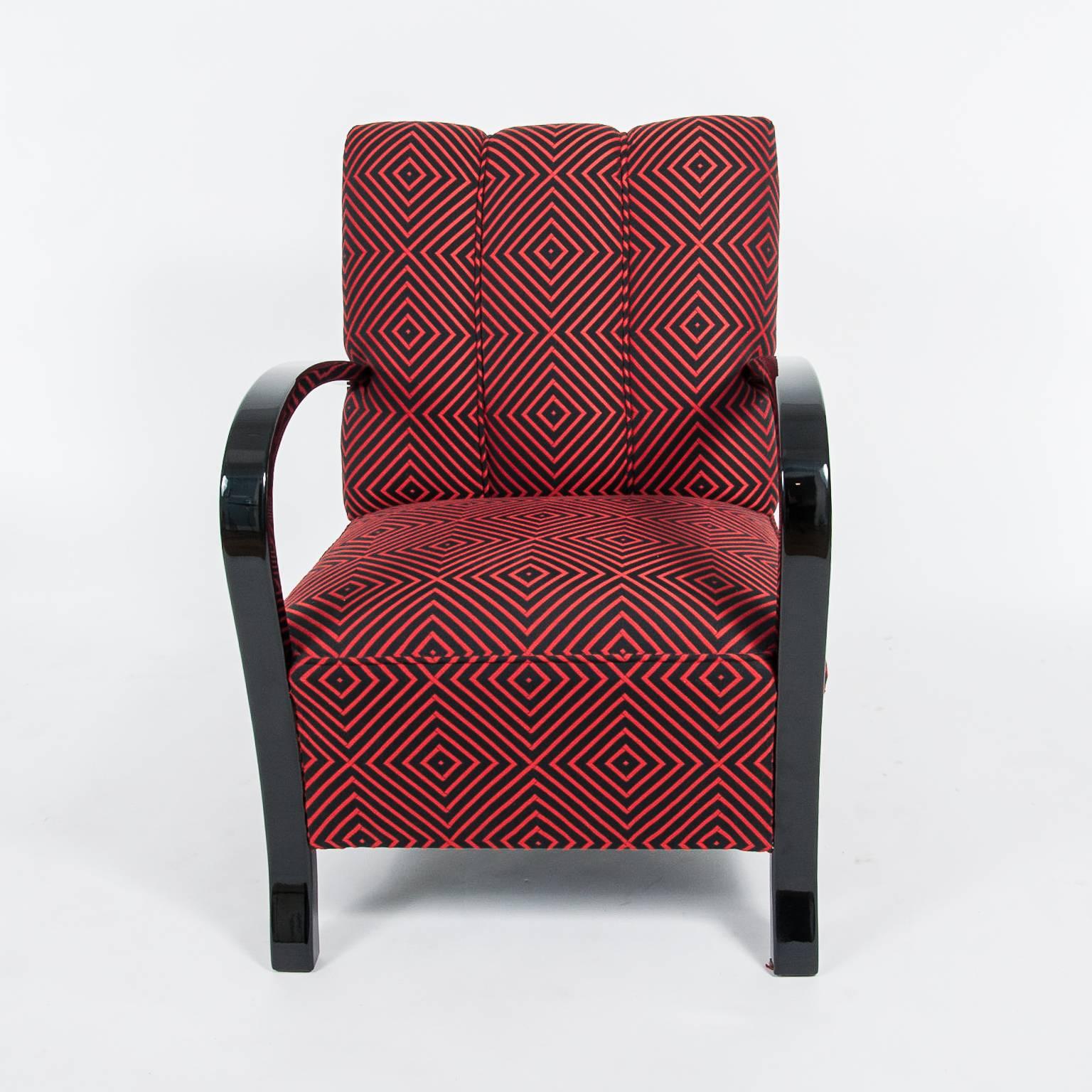 A wonderful Art Deco club chair from France around 1940 with a new upholstery in a red and black rectangle Art Deco pattern fabric. 
The chair has been restored and is in ready-to-use condition.