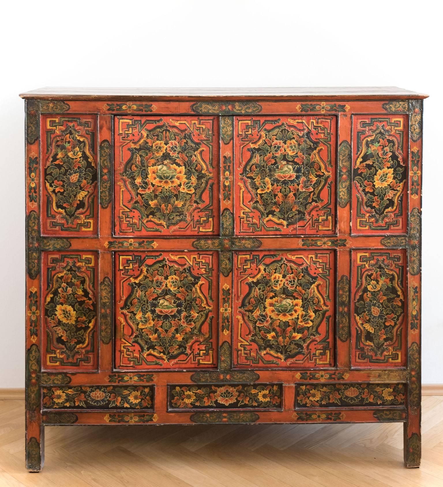 A unique Tibetan 19th century pinewood cabinet decorated with traditional colored floral paintings. These cabinets were often used as family altars. Furthermore, they were used as storage for important religious scrolls, formal silk clothes, family