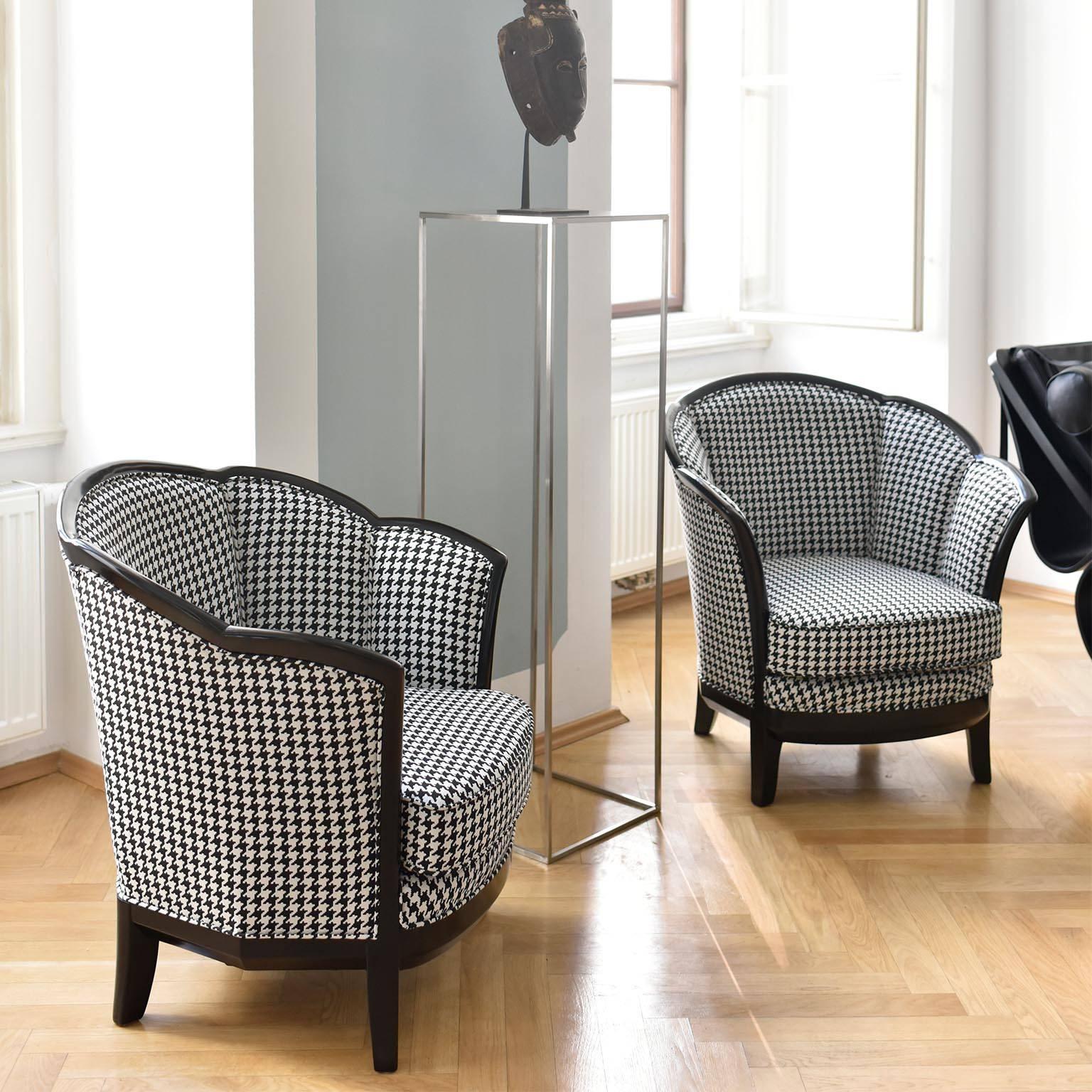 A pair of ebonized Art Deco bergère/club chairs with a nice shaped curved backrest. The Bergères were reupholstered with a beautiful high-quality fabric from the traditional Vienna manufacturer Backhausen.

This fabric has 50.000 Martindale