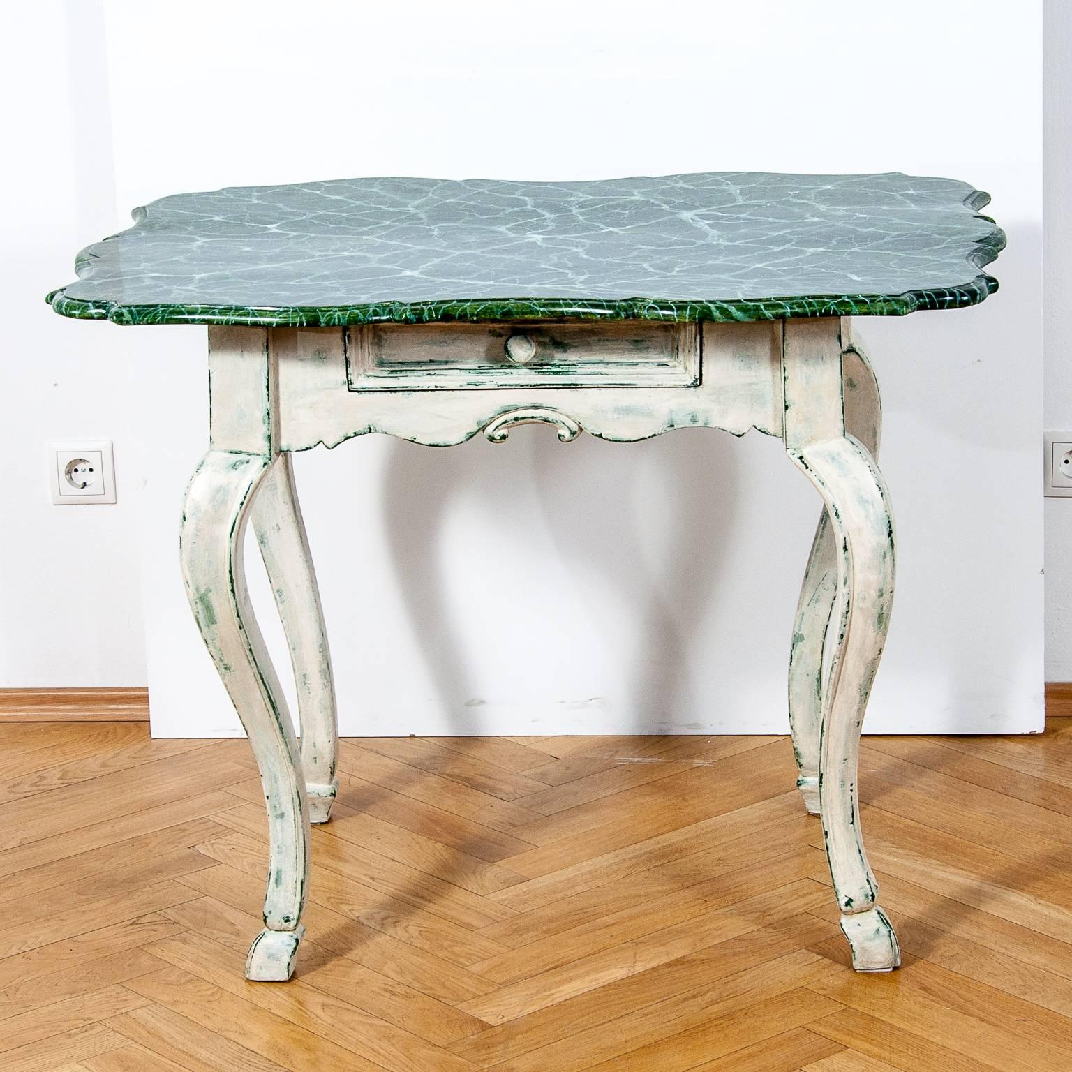An elegant hand-carved 19th-century walnut wooden Baroque table in the style of Louis XV.
The table has a new white-green washed finish in the Gustavian manner.
The top of this piece is painted in beautiful marble imitation called „a faux marble “.