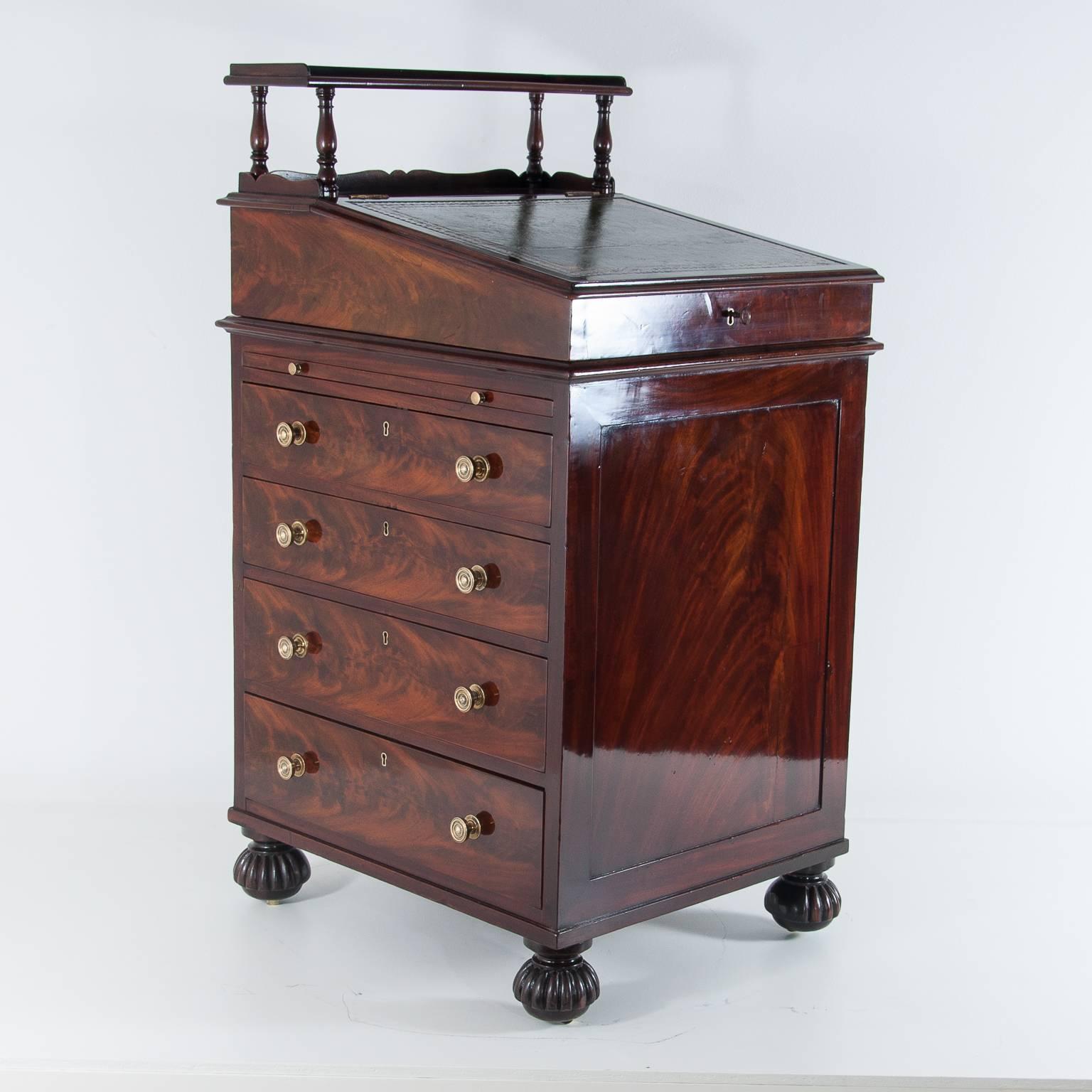 Late Regency mahogany Davenport made to a Gillows design, the top with turned spindled gallery, pull-out pen drawer, sloping hinged fall inset with leather writing surface, interior fitted with two working drawers and two dummy drawers, the whole