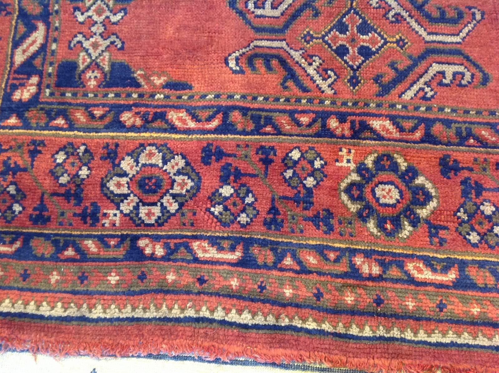Square red antique Oushak rug.