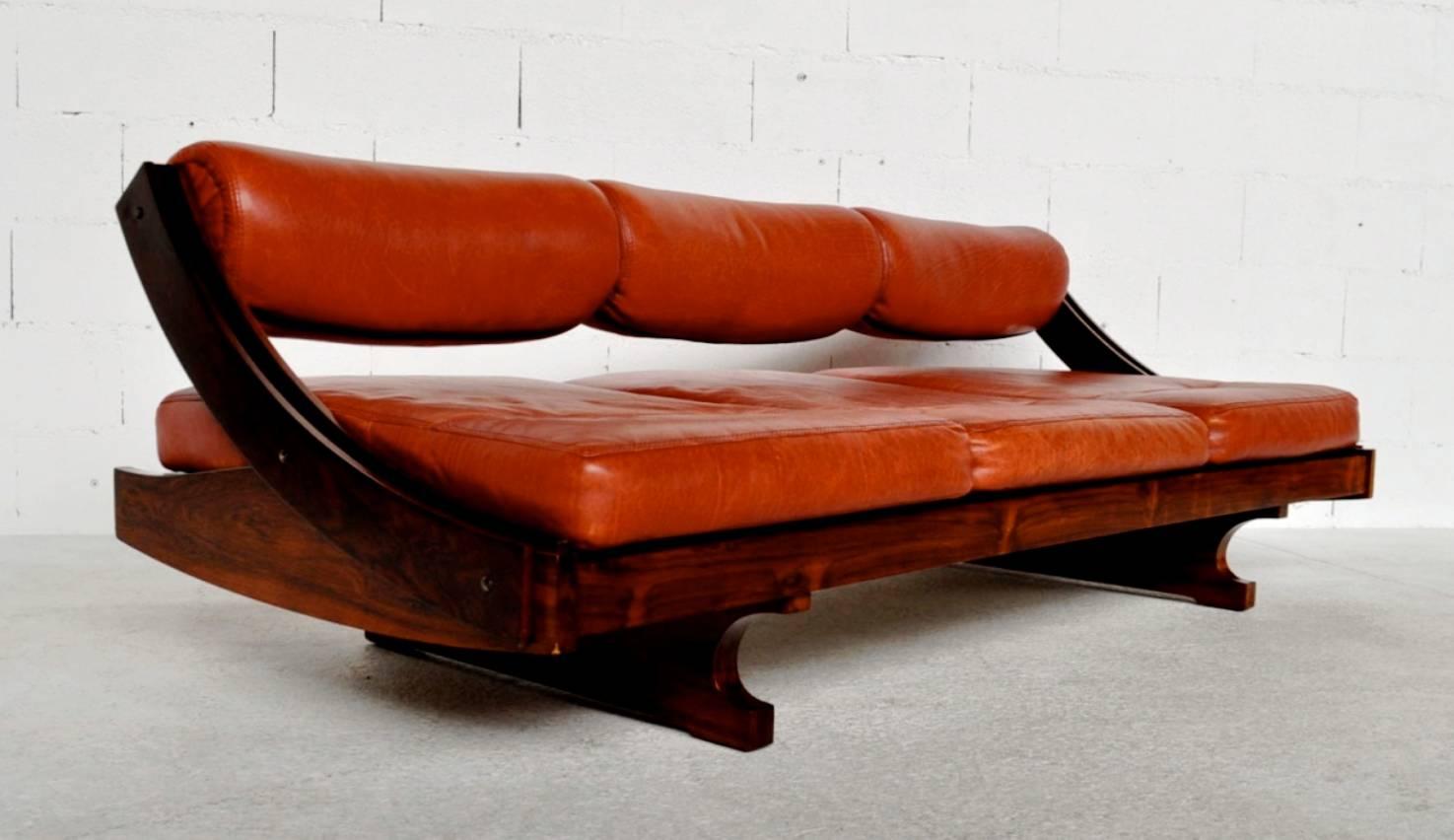 Striking rare modular GS 195 Sofa / Daybed by Gianni Songia for Sormani, Brazilian Rosewood veneer and original red leather, 1963.

The back rest can be placed in two positions, as a sofa, or as a daybed.

Sormani, an italian furniture maker,