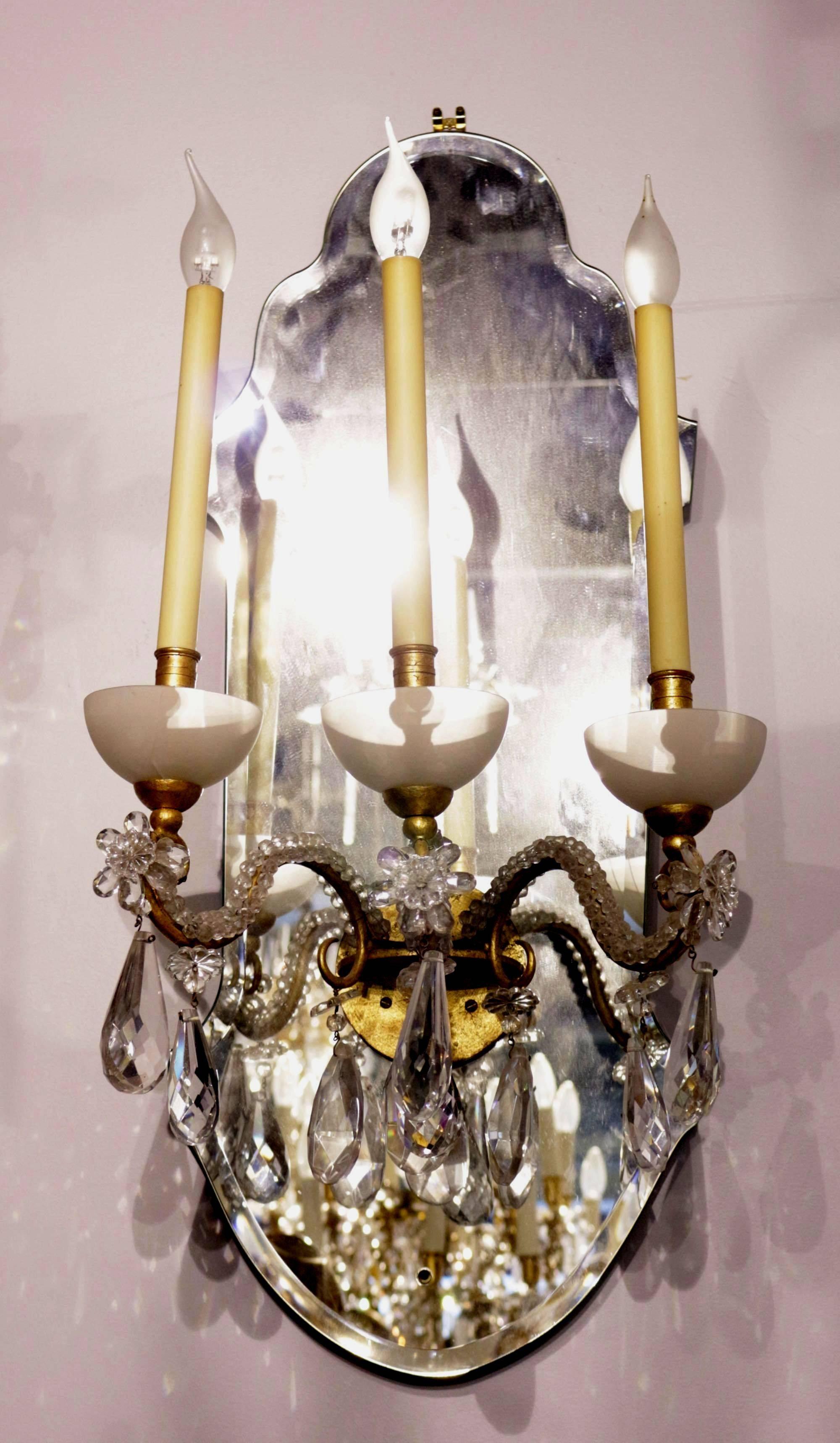 Nice pair of wall lights, France, late 1960s.
The gilded metal arms covered with glass beeds, flowers, and glass pendants.
Eight pairs available.
               