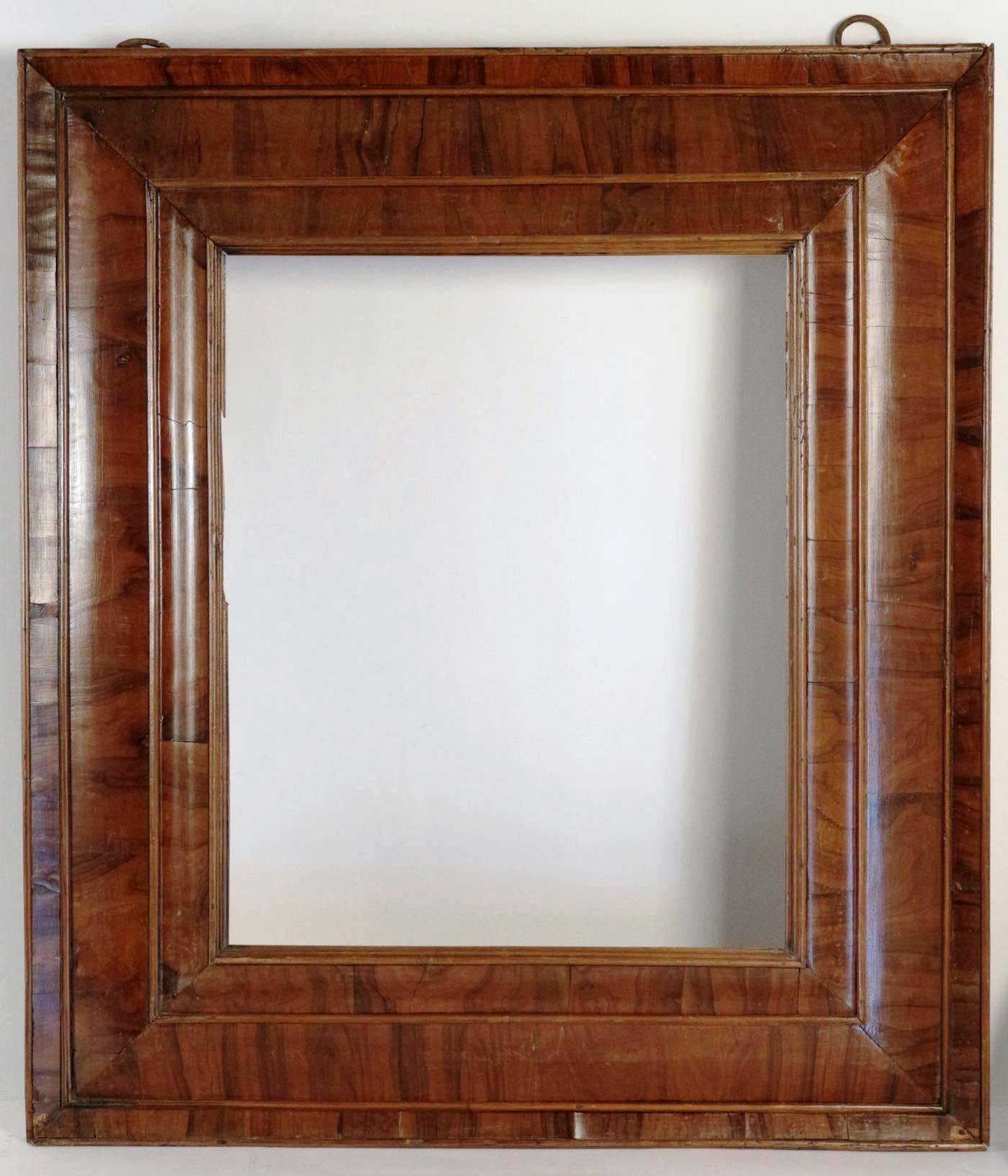 Extraordinary 17th century frame mounted as mirror, nutwood veneer, spectacular
with original hooks, 
Mirror plate later than frame
Fabulous condition
As a frame, sight size is 56 cm x 45.5 cm 
Later mirror plate.