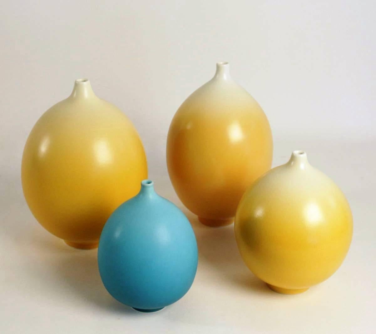 Marc Uzan 21st century

Set of four blue and yellow porcelain vases by Marc Uzan, signed.

Marc Uzan : blue measures H : 17, diam : 13
 yellow H : 20, diam : 16
 Yellow H : 25, diam : 19
 Yellow H : 26, diam : 19.
   
 