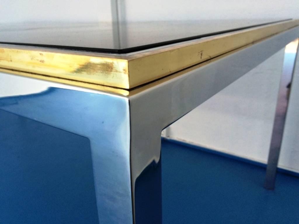 Nice dining room table or desk in the style of Willy Rizzo, in chromed and gilded metal with smoked glass top, 1970s.
Please note that tabletop is transparent glass
Measures: L 2 m.
W 1 m.
H 73 cm.
 