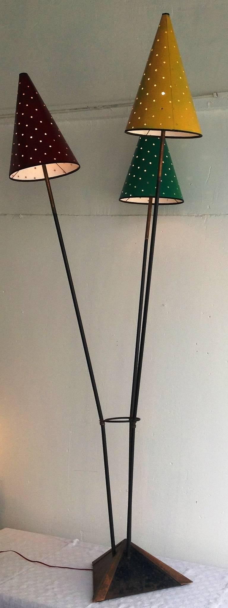 Rare floor lamp with three lights, attributed to Jean Royère, 1950s.
The shades ornate with punched stars seemed to be a special order from Jean Royère to Alexandre Jardon (French lampshade maker, still alive).
The floor lamp is made of black