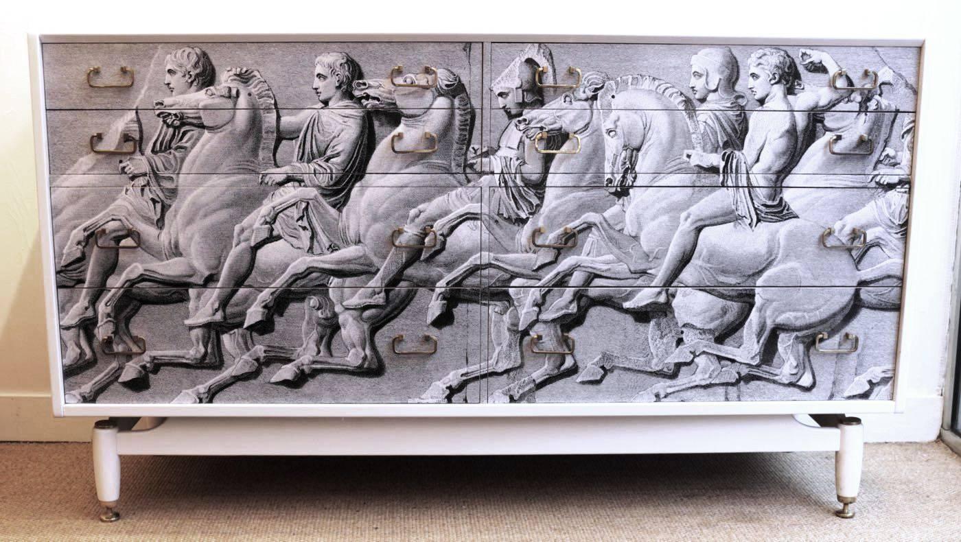 Spectacular revamped 1950s sideboard by Donald Gomme revamped in the taste of Fornasetti.
Elgin Frieze,
Elegant sideboard from the 1950s, with Elgin frieze parthenon (Fornasetti style) design applied on face. (Customized recently).
It is in the