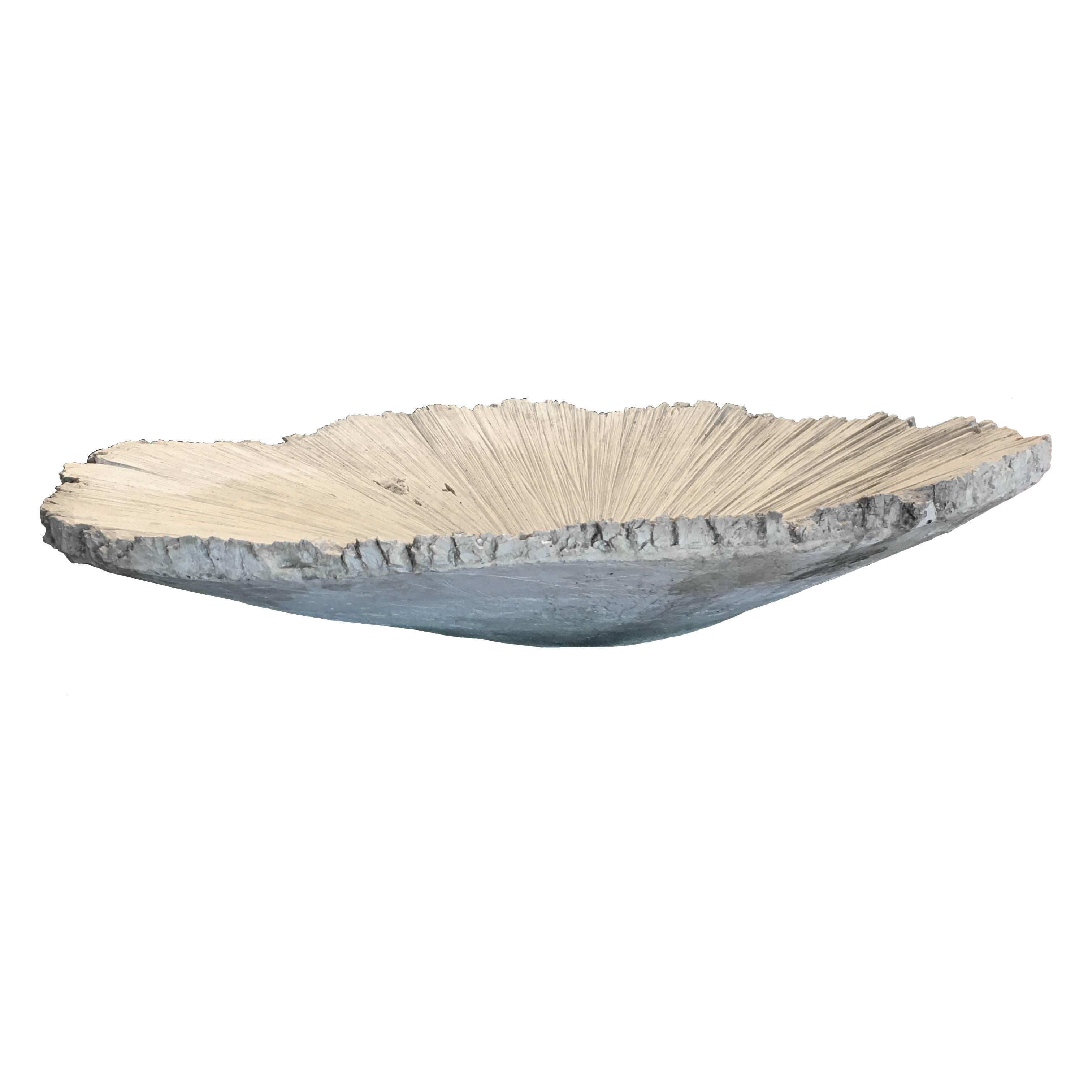 A stunning piece of design, this woodcut stone bowl adds drama and interest to any space indoors or out. Its asymmetrical presence is as eye-catching as it is beautiful. Display alone, or fill this bowl with fruit or other decorative