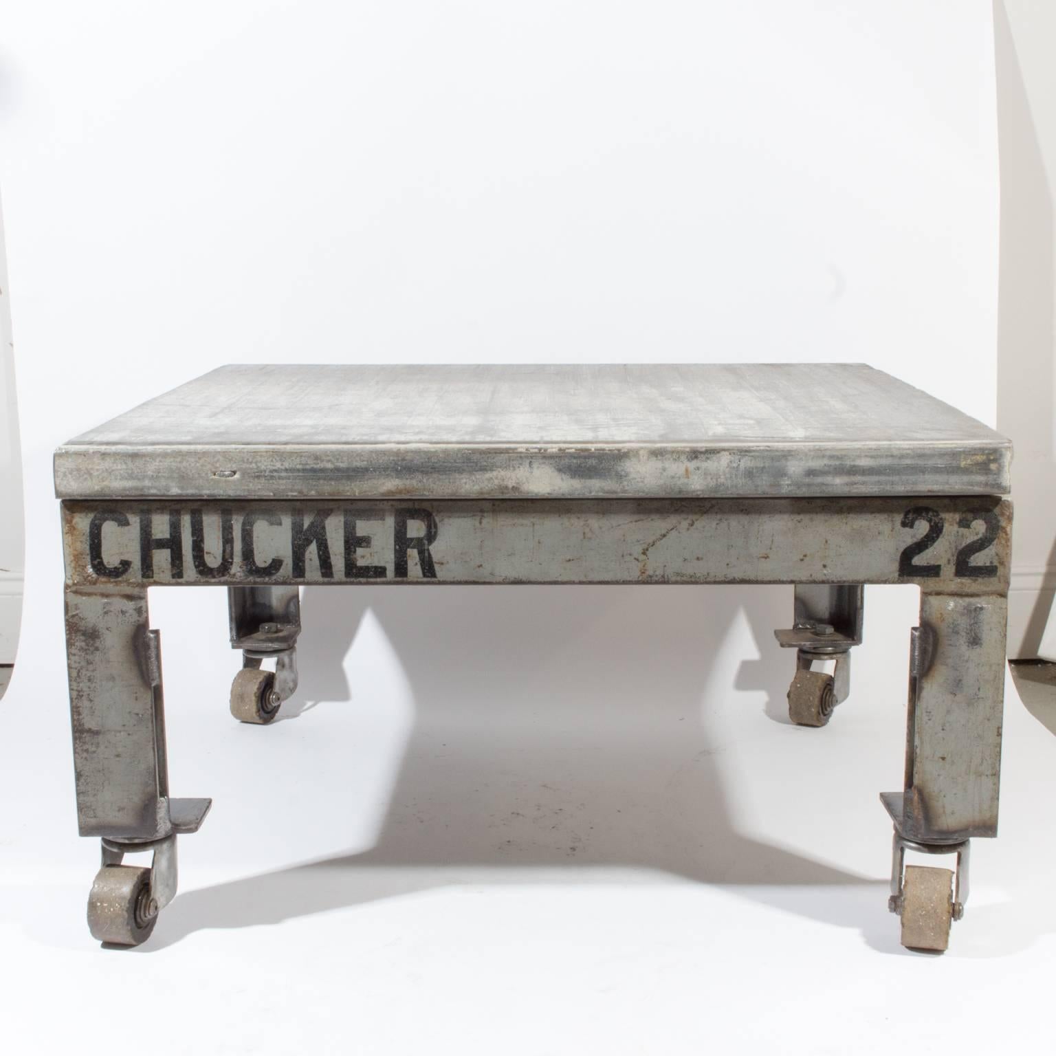 A unique Industrial Design, this cocktail table is crafted from a vintage Belgian bricklayer's pallet and includes four wheels. We like the original writing featured on two sides with chucker 22. Measures 32.25 inches by 31.5 with height at 18