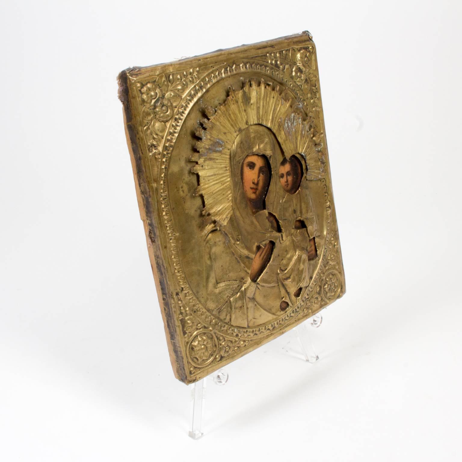 Early 19th century Russian Icon of Our Lady of Iveron hand-painted on oak and covered in a brass repoussee. Measures 8.5 inches by 10.5 inches and 1 inch thick. Also known as the Panagia Portaitissa or the Iviron Theotokos, this icon is an Eastern