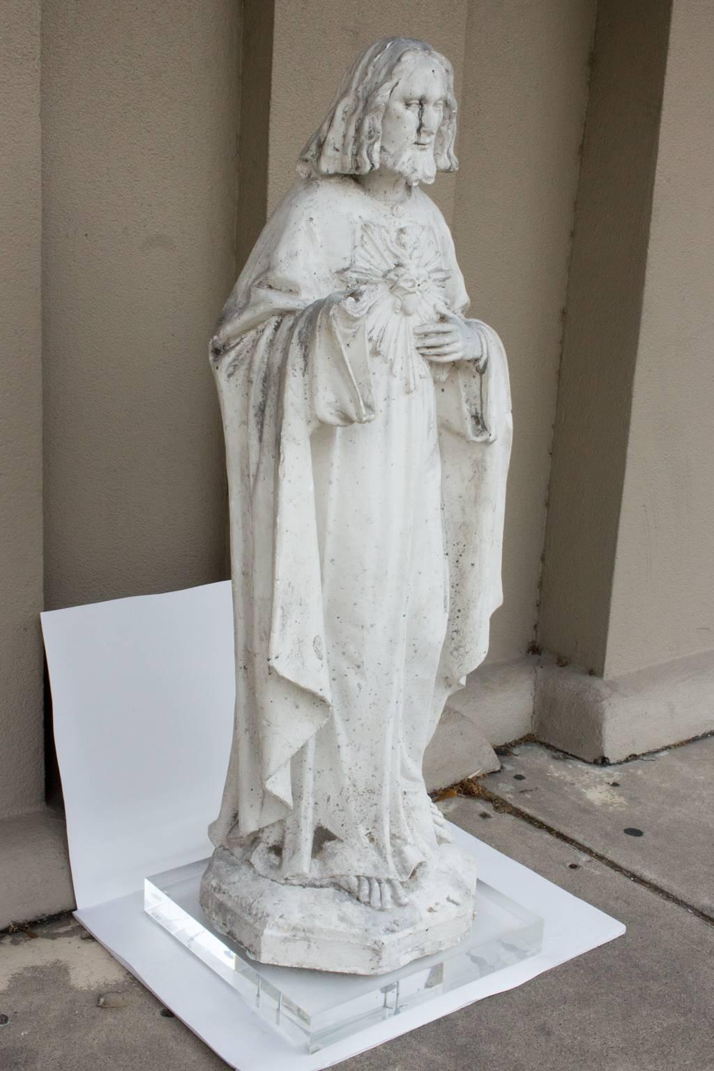 Truly a very special one of a kind religious piece, this large plaster statue features the lovely iconic image of the seated Jesus and includes an acrylic base. Recently discovered in Bruges, Belgium and is the considered the original 