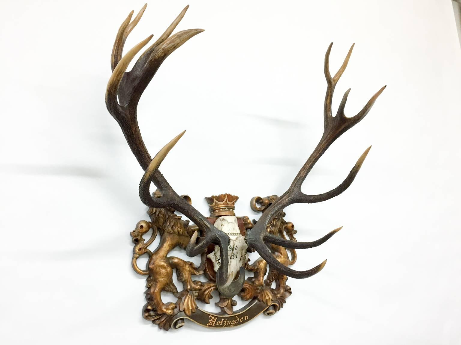 This is a historic 19th century Austrian Red Stag trophy on a hand-carved, painted plaque bearing the word 