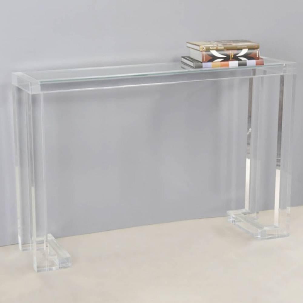 The Ava acrylic and glass console brings sophistication and excitement to a transitional environment. This design looks great as an addition to almost any aesthetic with a pop of modern. Crafted of thick Lucite with an inset glass top. Created by