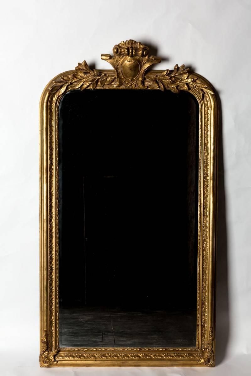 Hand-carved with beaded detail and exquisite aged gilt painting technique, this piece was created in Biarritz, France and has a lovely beveled edge mirror installed. These are newly crafted pieces and available in limited stock.

Measures 65