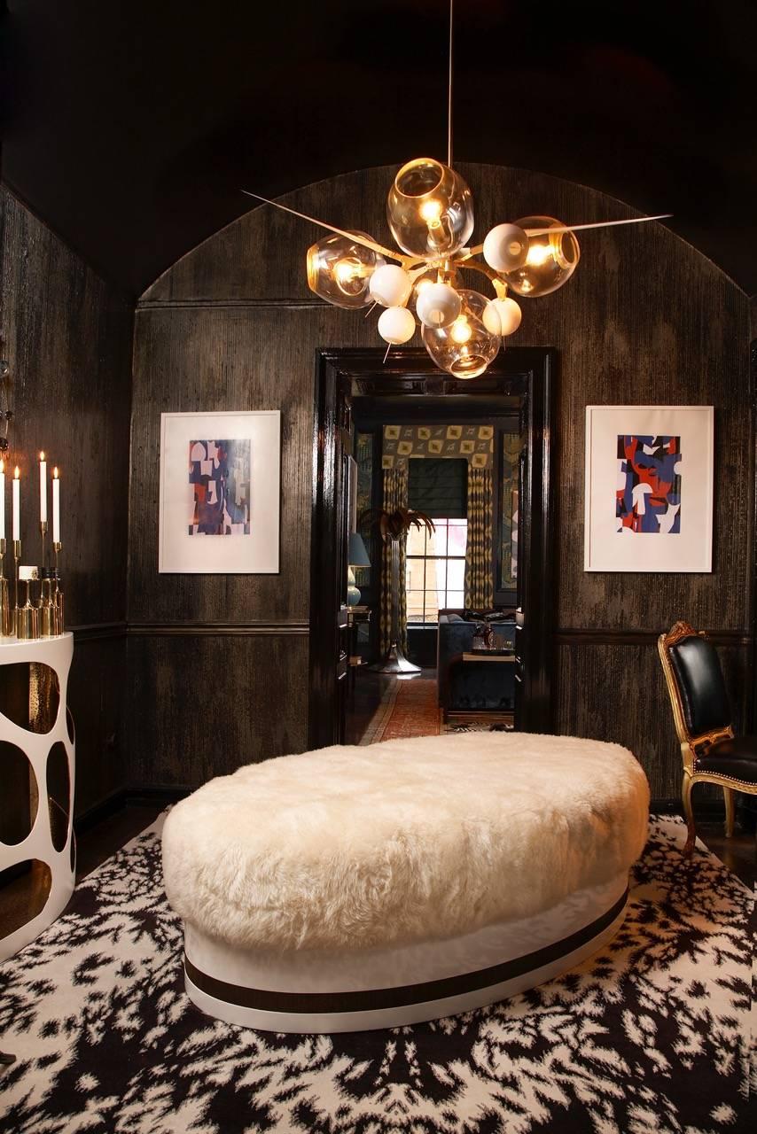 This ultra chic and luxurious ottoman by Azadeh Shladovsky was presented by interior designer, Katie Scott, in her jewelry themed room at the 2015 NYC holiday house.

Long haired Patagonian sheepskin ottoman over a maple frame and white lacquer