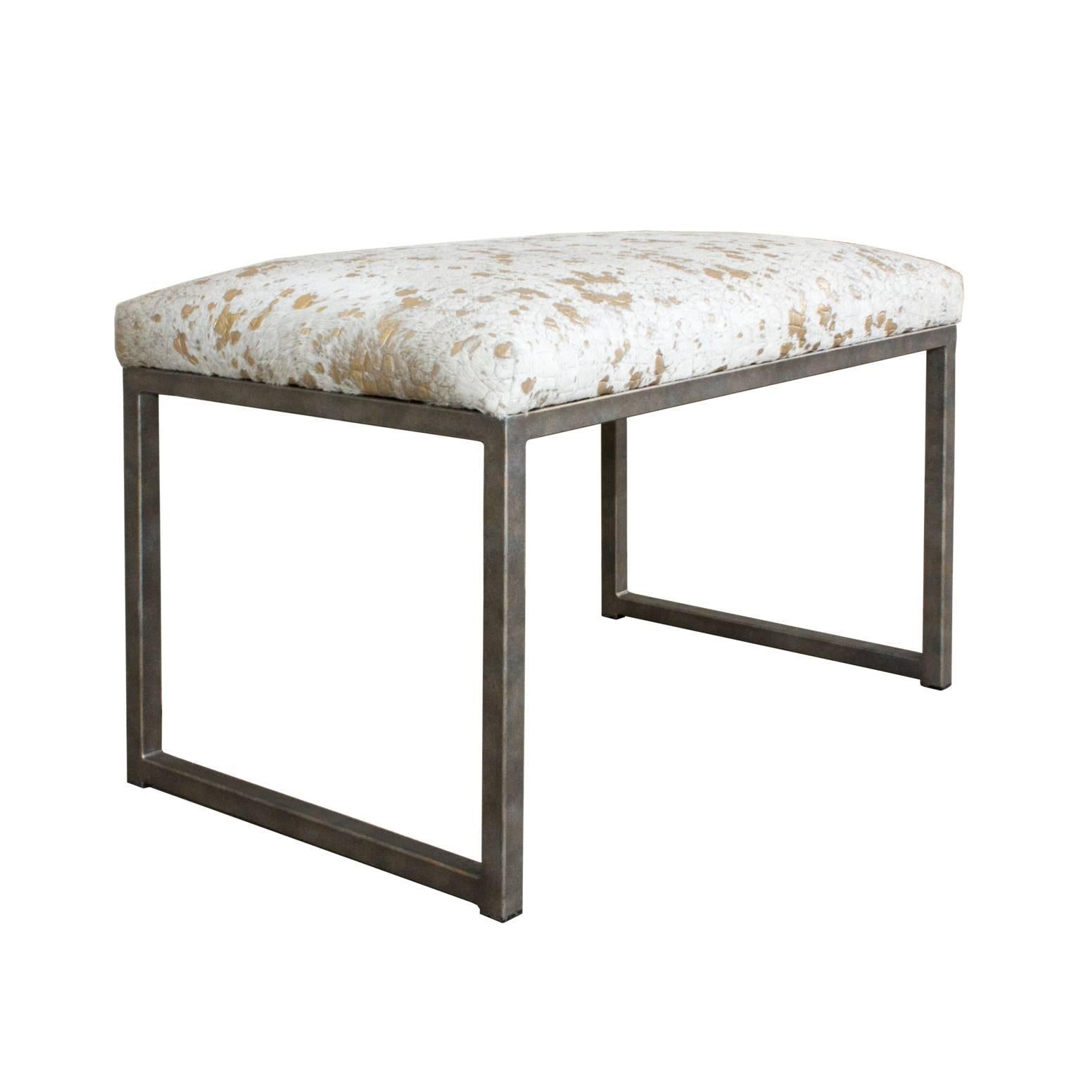 These Brazilian benches feature a gold metallic splash embossed cowhide are crafted with a custom iron base with slight gold finish. A custom-made piece, of which we have only two available. The cowhide used is a natural Brazilian cowhide, which has