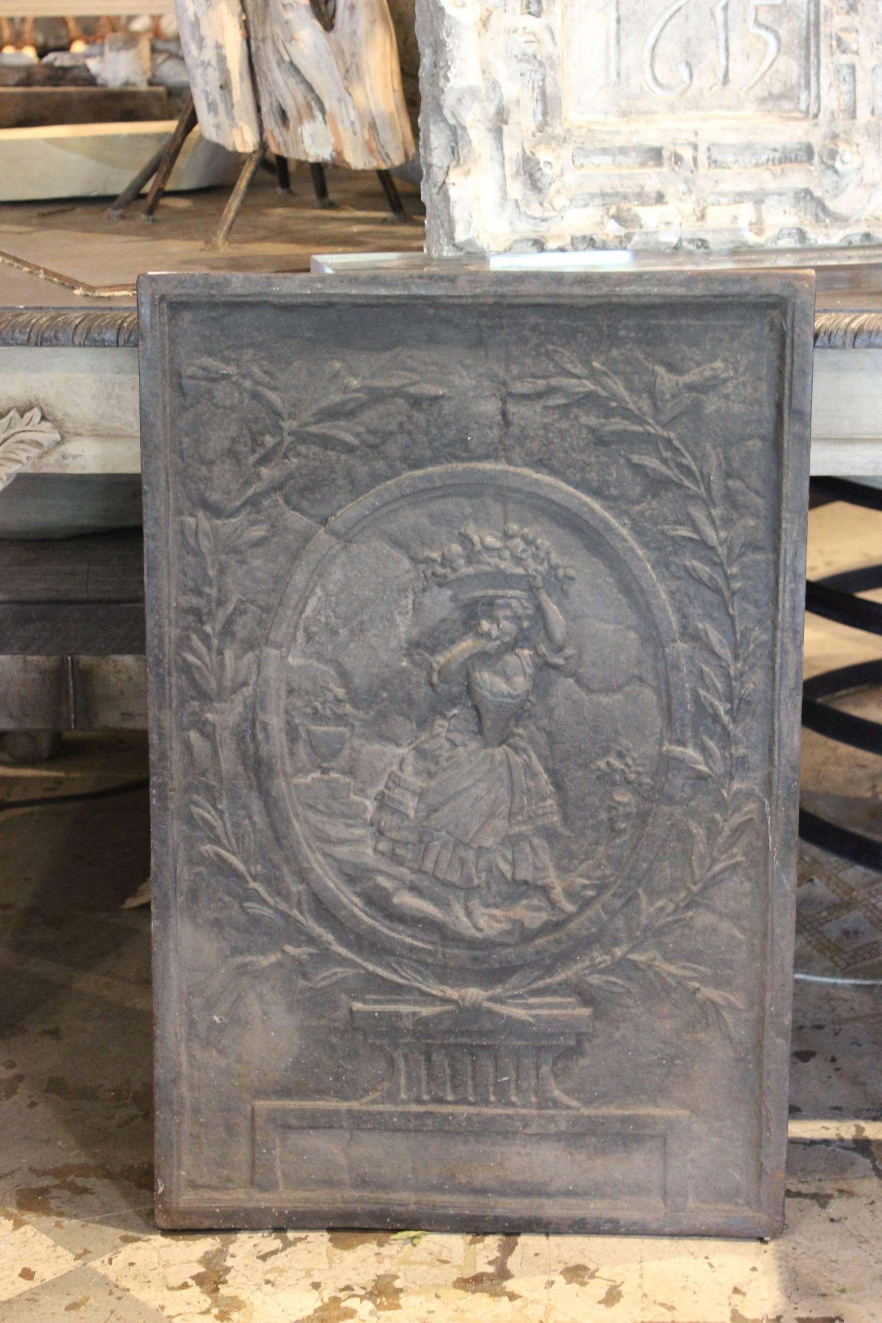 Discovered during our recent time in Chartres, France we love this large-scale iron fireplace screen. Crafted in iron, the relief depicts a beautiful French girl with laurel leaf detail. Lovely used in the fireplace but also would be very nice