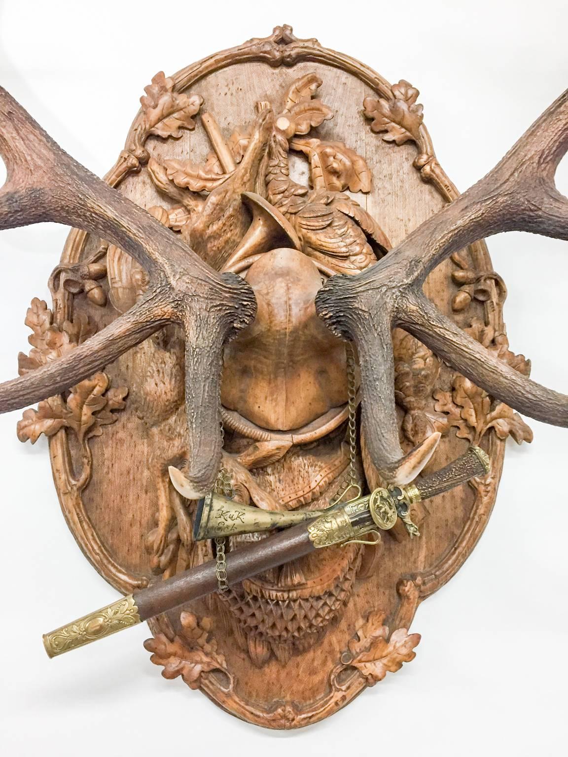 This is an extraordinary 19th century Austrian Red Stag trophy of Emperor Franz Josef which includes the personal court and military swords of the Emperor as well as his hirschfänger (hunt sword), mounted together on an original, hand-carved plaque.