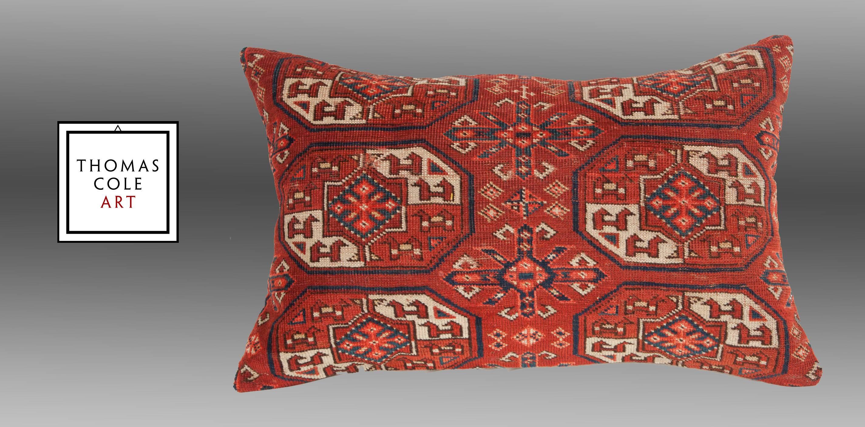 A pillow fashioned from a colorful Yomut Turkmen/Turkoman tribal bag.   

The colors are all derived from natural dyes and the condition is good, with no holes, repair or stains. It comes with an insert to accommodate the filling.   

The