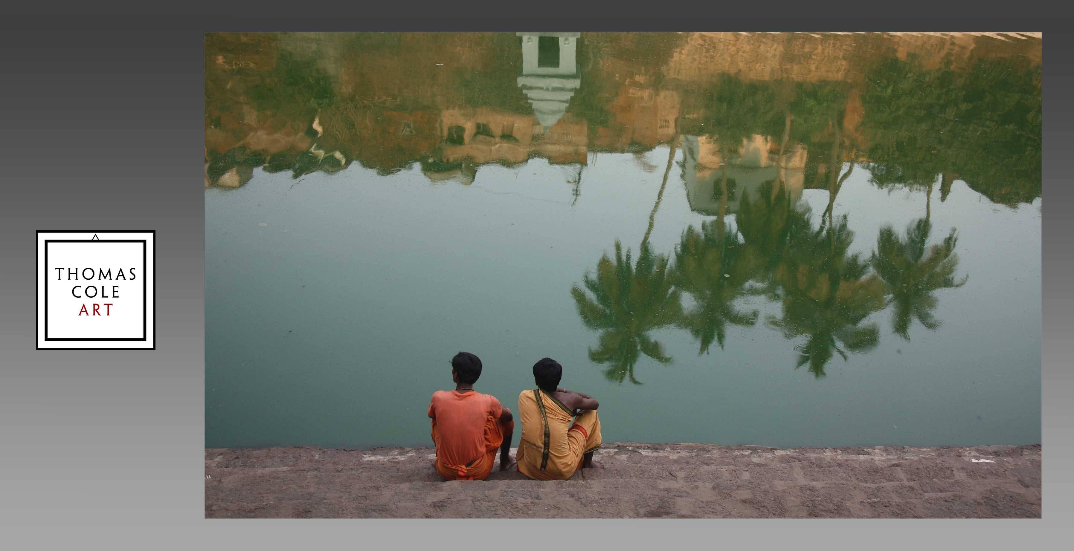 These two young men, devotees of Krishna, are seen
sitting beside one of the major bathing pools located
near the centrally located Jagganath temple in the
center of Puri (Orissa). With the sun just coming up,
this quiet spot on the pilgrimage