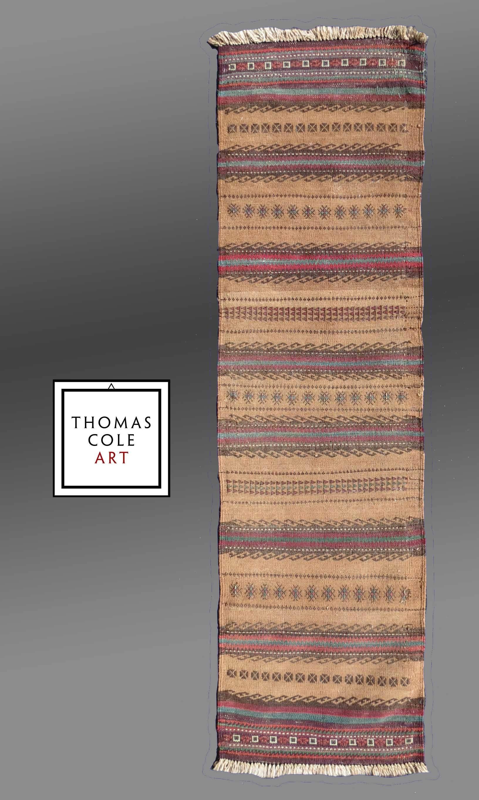 A colorful and intact tribal weaving from the Baluch people of Asia. 

The colors are lovely contrasted against the camel colored wool ground. 

Originally conceived as an eating mat (a table cloth in our culture), it is ideally suited as a