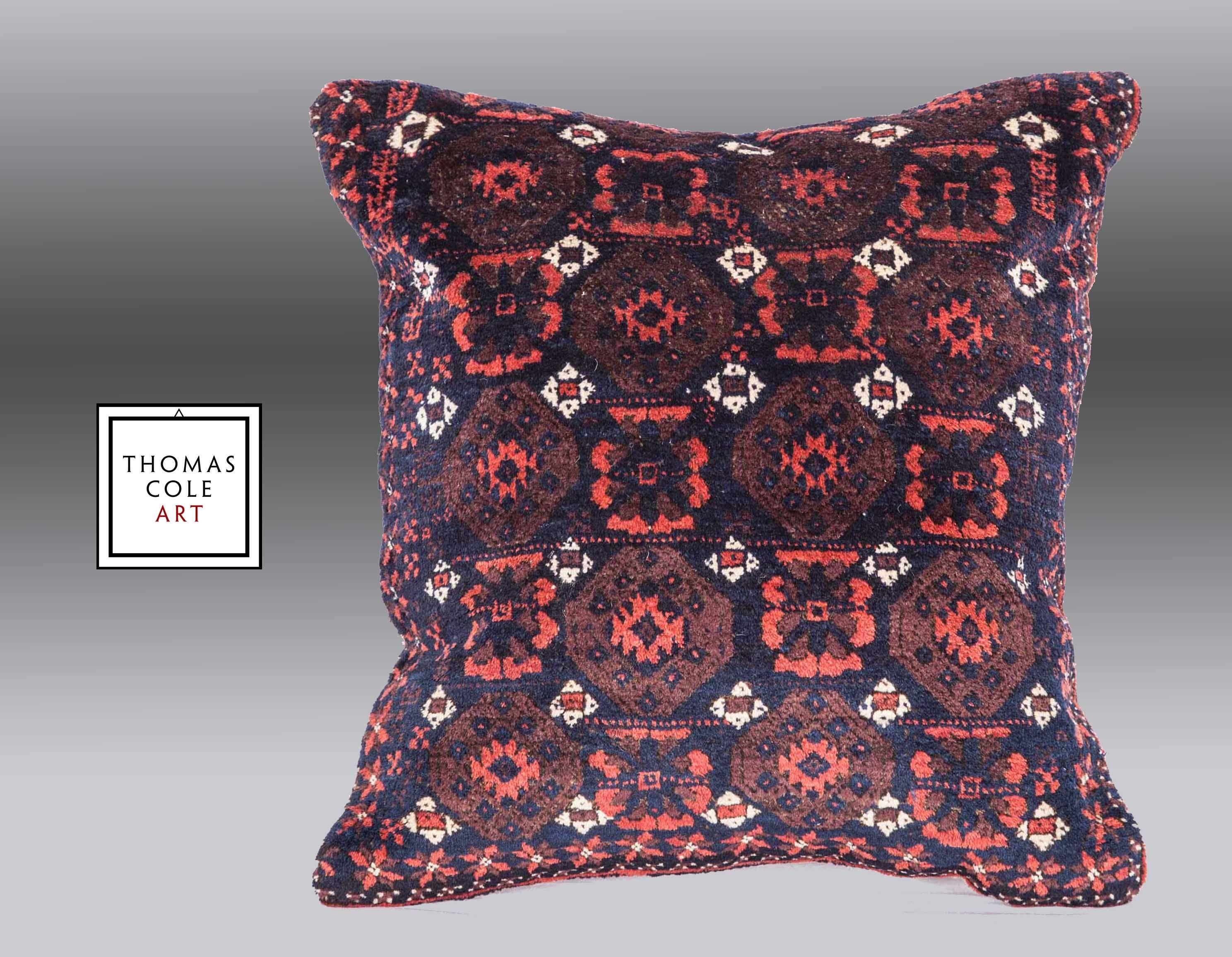 A pillow fashioned from a colorful Baluch tribal rug. Measures: 20.4