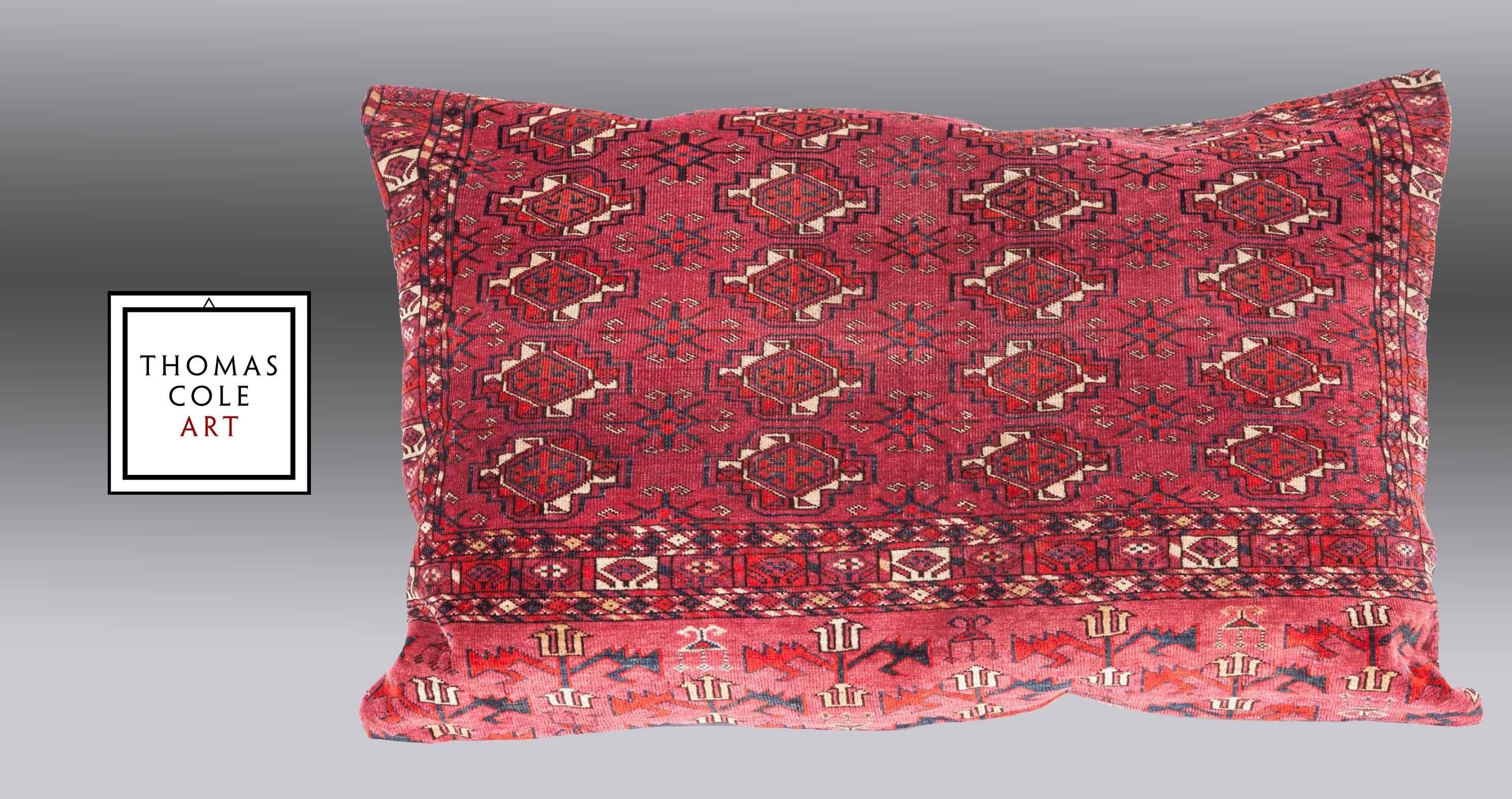 A pillow fashioned from a colorful TekkeTurkmen tribal bag that was woven for dowry purposes and is quite plush. Measures: 38.5