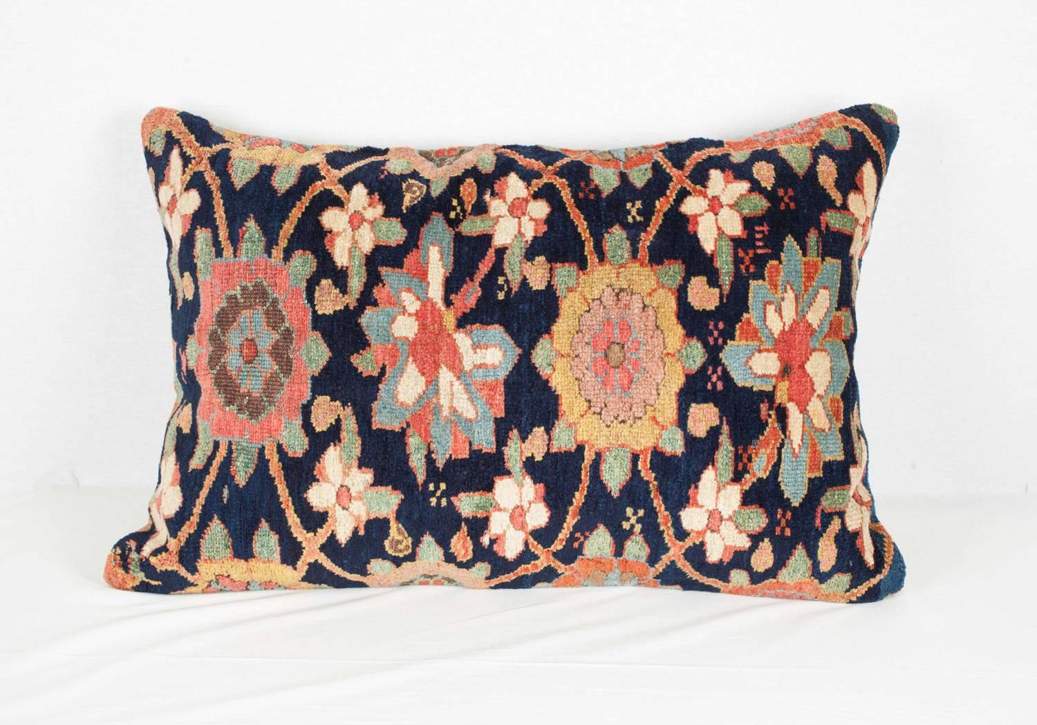 A pillow fashioned from an antique Northwest Persian carpet.  The colors are all derived from natural dyes.  The condition is good with no holes, repair or stains.

It comes with an insert to accomodate the filling.
FILLING NOT PROVIDED

Item