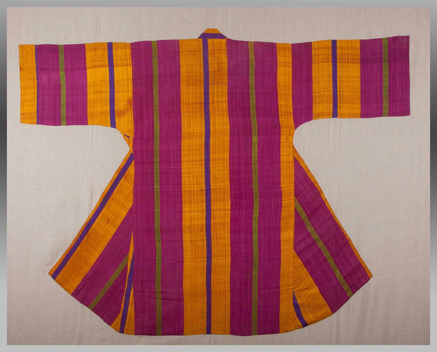 An antique hand-loomed silk coat which has been hand-sewn down onto a linen ground, ready to be stretched over a wooden frame and to be hung on the wall. It will make a very dramatic artistic statement with such a graphic image with a bold, colorful