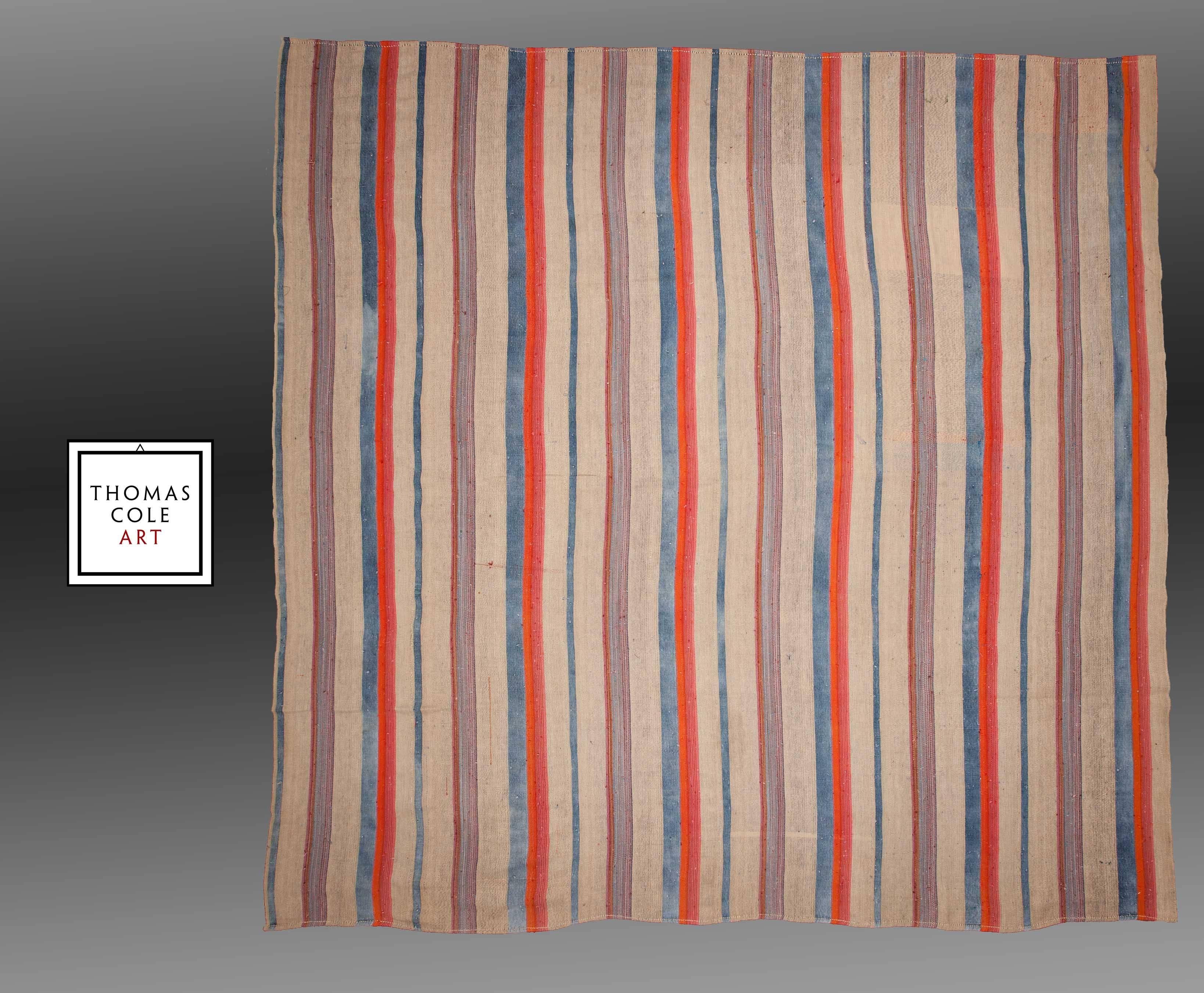 A large Turkish flat-weave made in southern Turkey, composed of both cotton and wool, a rare combination. The off-white/brown is cotton, while the light blues, red and orange colors are composed of wool. 

It is in good condition with no holes or